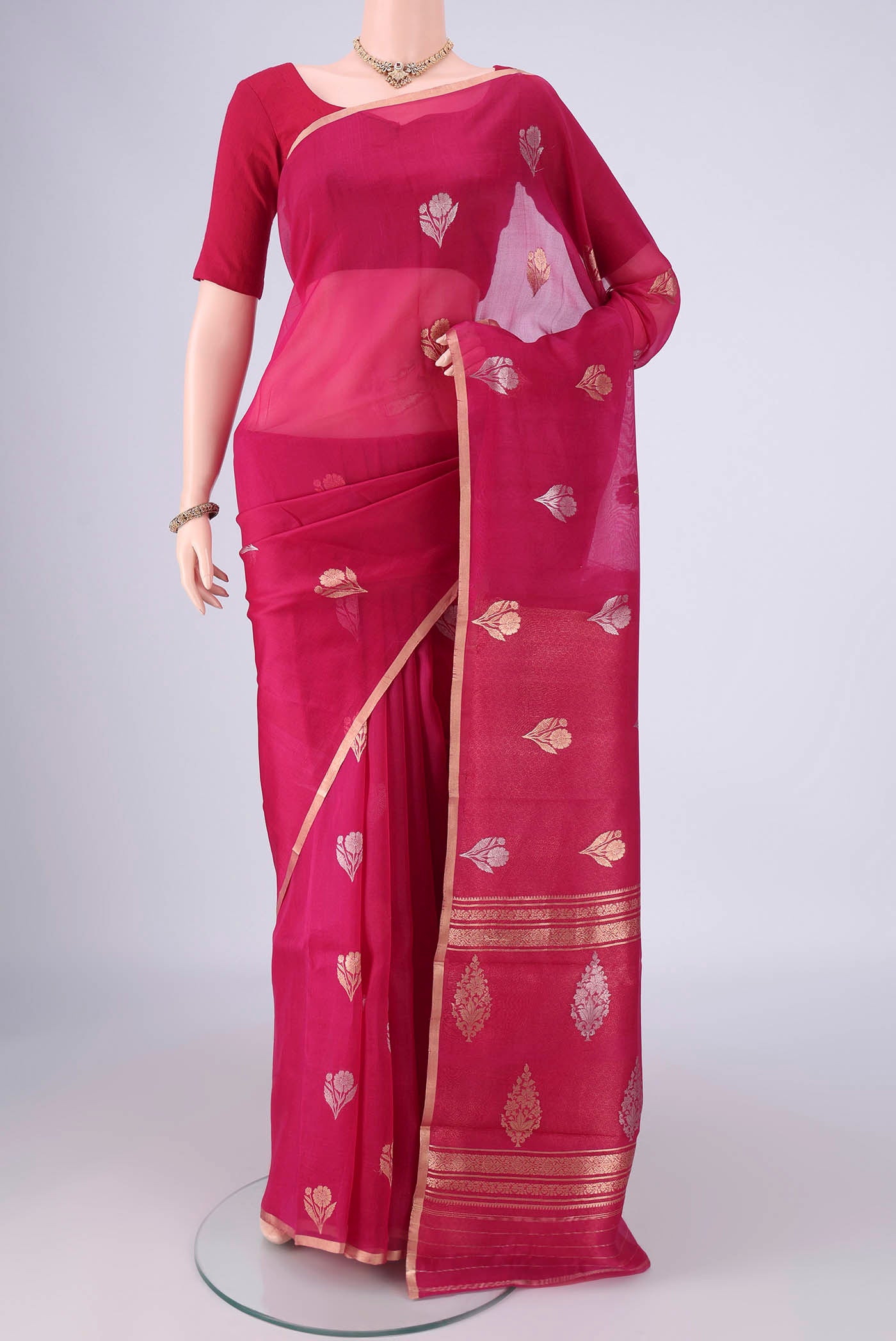 Pink Organza Silk Saree with Zari Butta on the body and Zari Border.  displayed on a mannequin