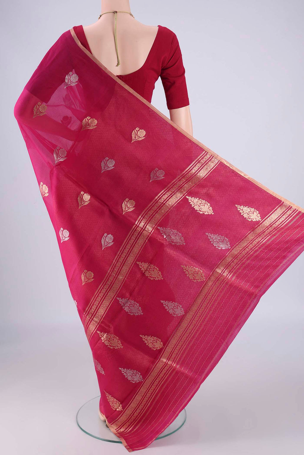 Flat view of Pink Organza Silk Saree with Zari Butta on the body and Zari Border. 