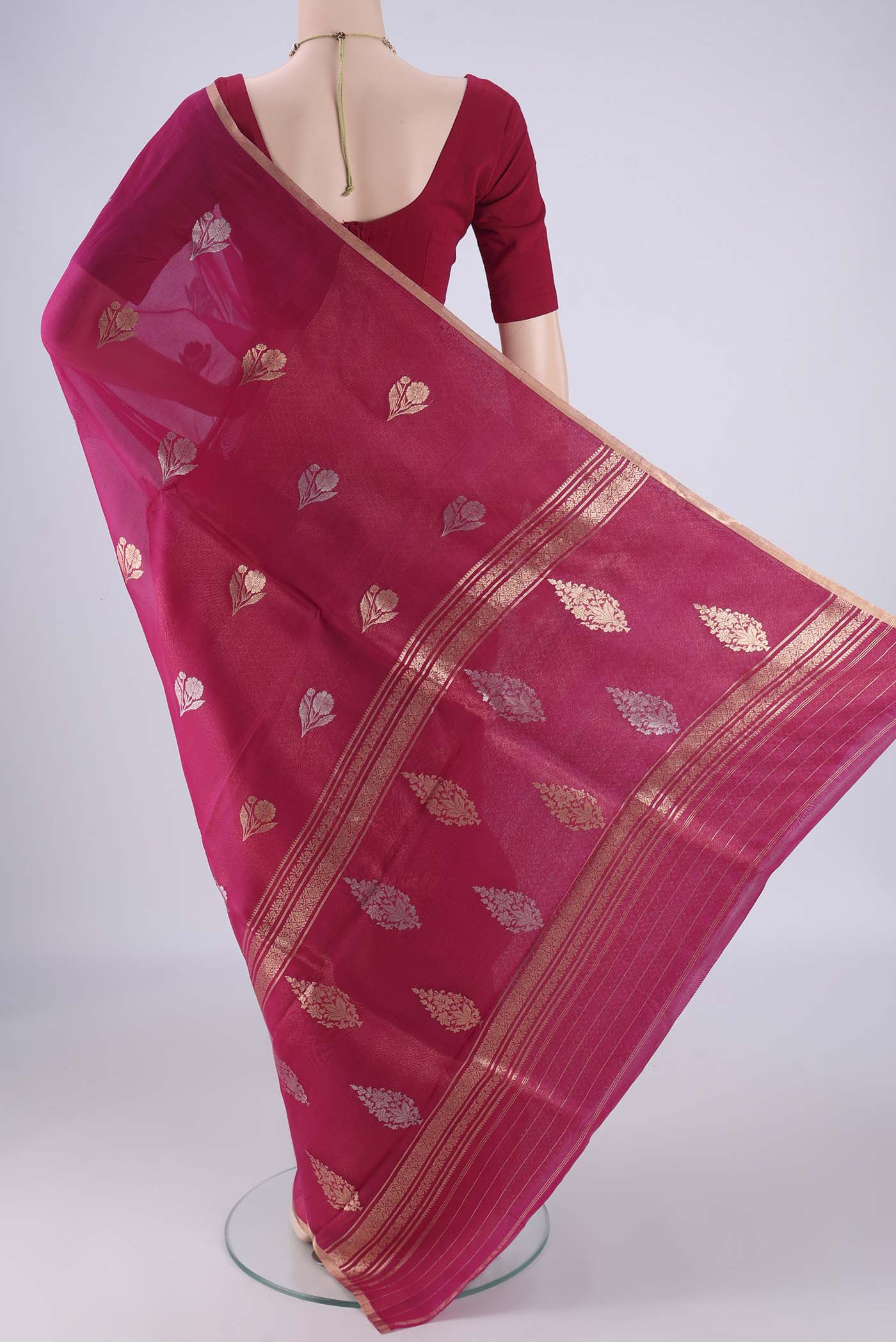 Flat view of Pink Organza Silk Saree with Zari Butta on the body and Zari Border. 