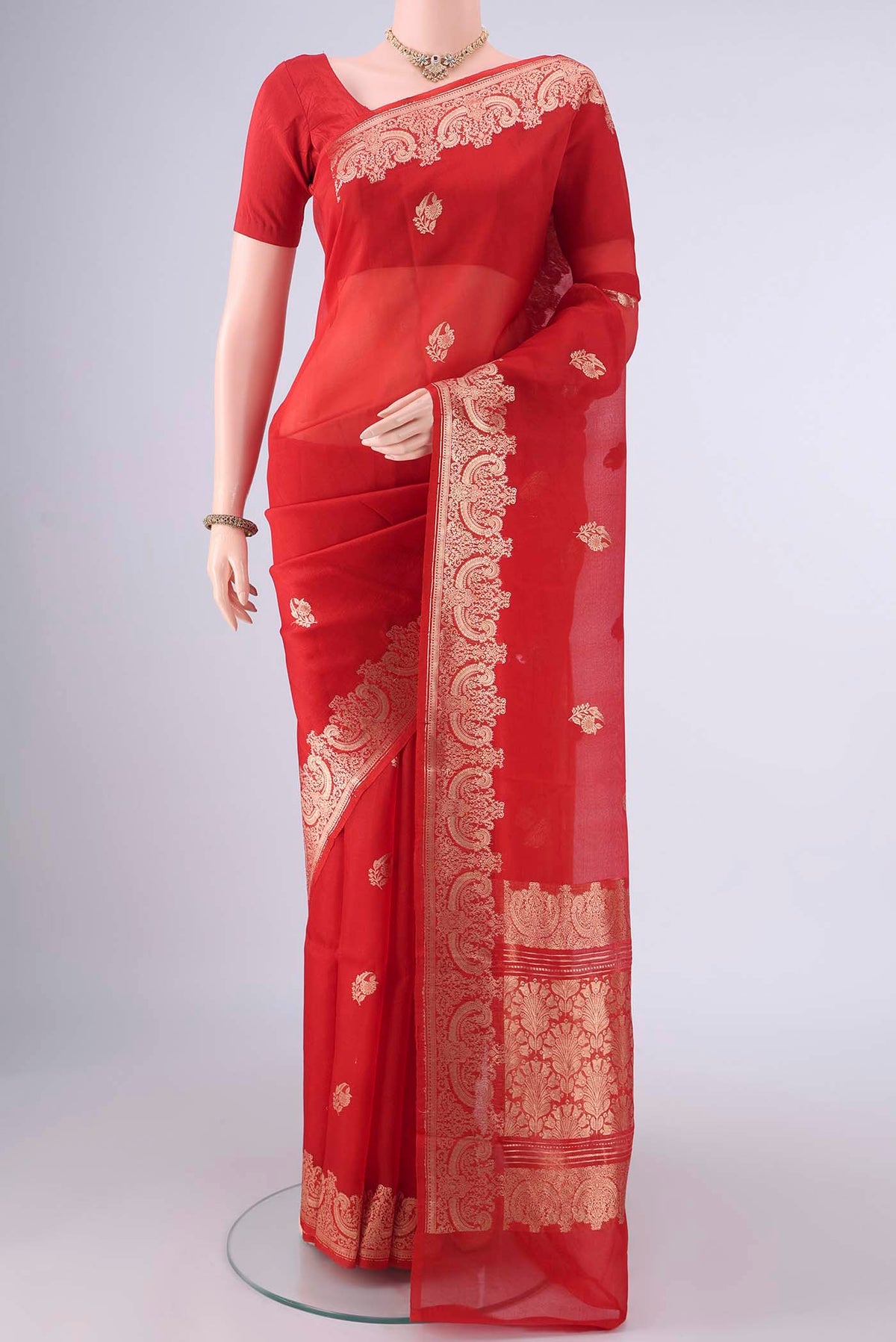 Red Banarasi Georgette Saree with Zari Butta on the body and Zari Border.  displayed on a mannequin