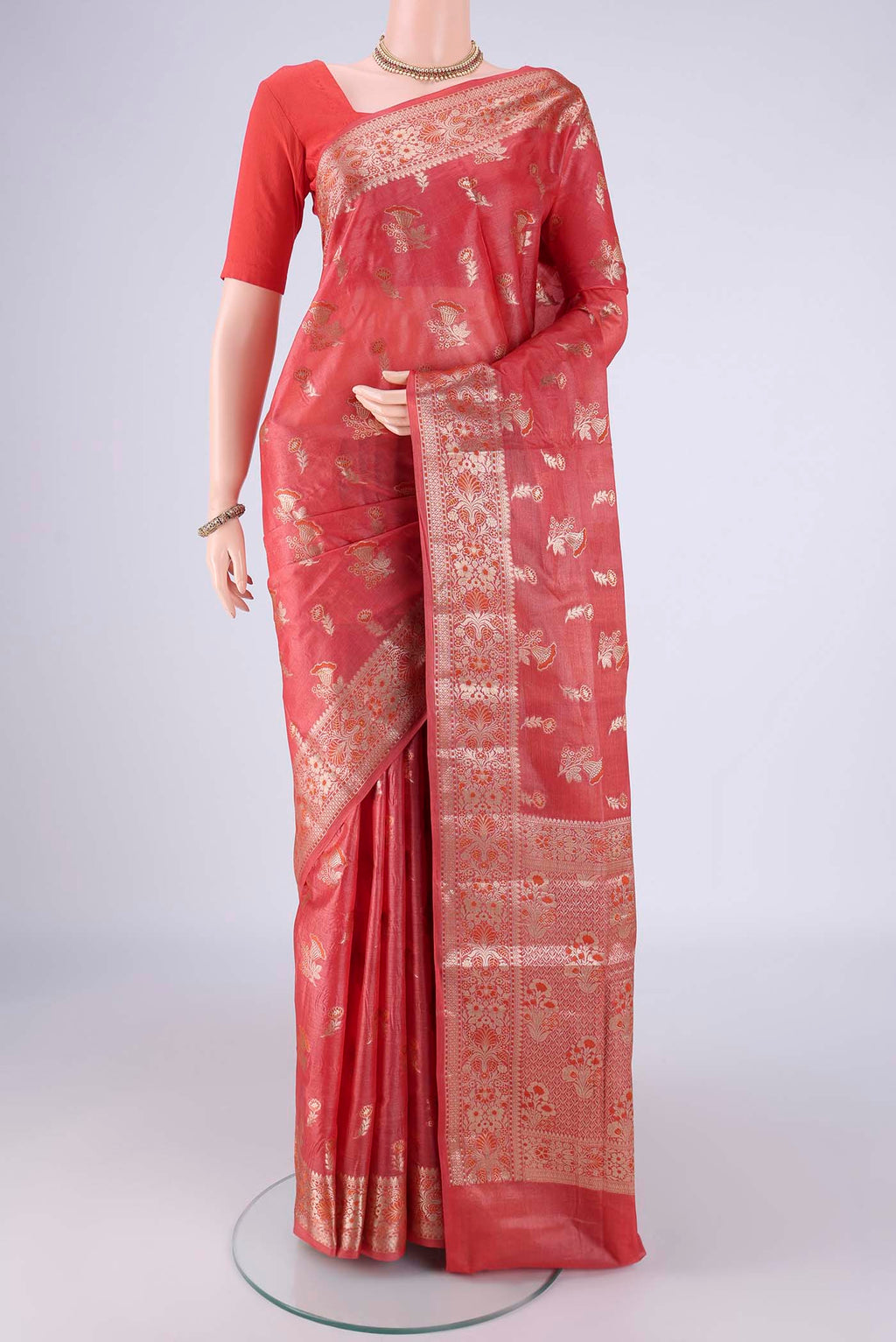 Coral Banarasi Tussar Silk Saree with Zari And Thread Butta on the body and Zari Border.  displayed on a mannequin