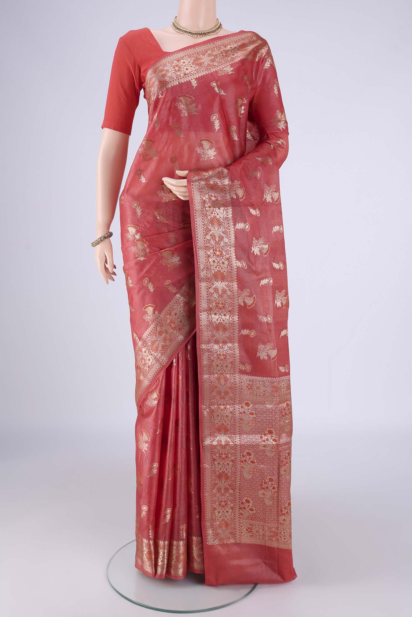 Coral Banarasi Tussar Silk Saree with Zari And Thread Butta on the body and Zari Border.  displayed on a mannequin