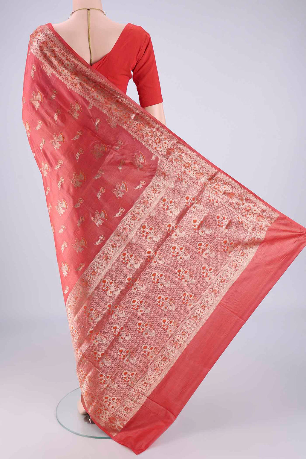 Flat view of Coral Banarasi Tussar Silk Saree with Zari And Thread Butta on the body and Zari Border. 