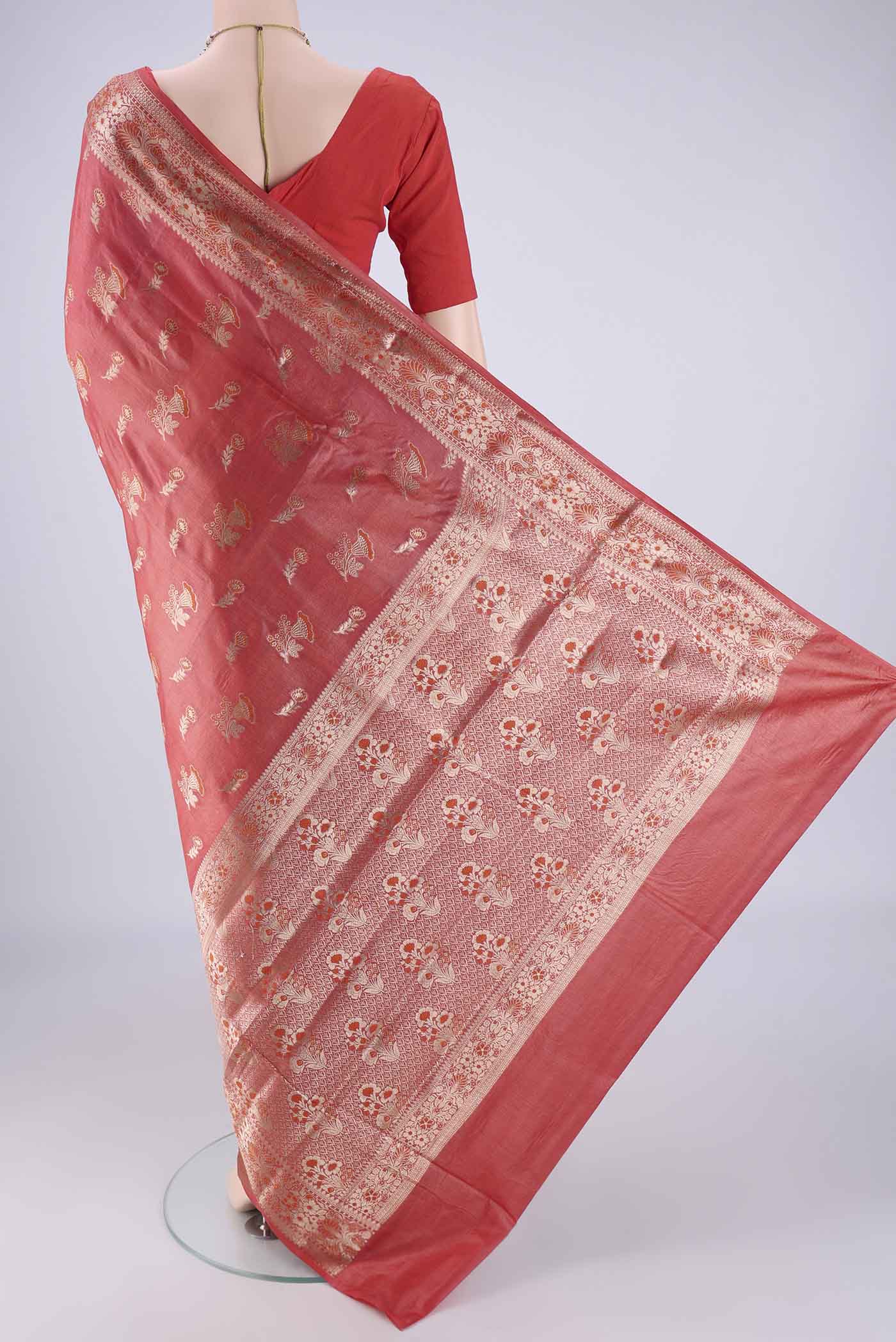 Flat view of Coral Banarasi Tussar Silk Saree with Zari And Thread Butta on the body and Zari Border. 