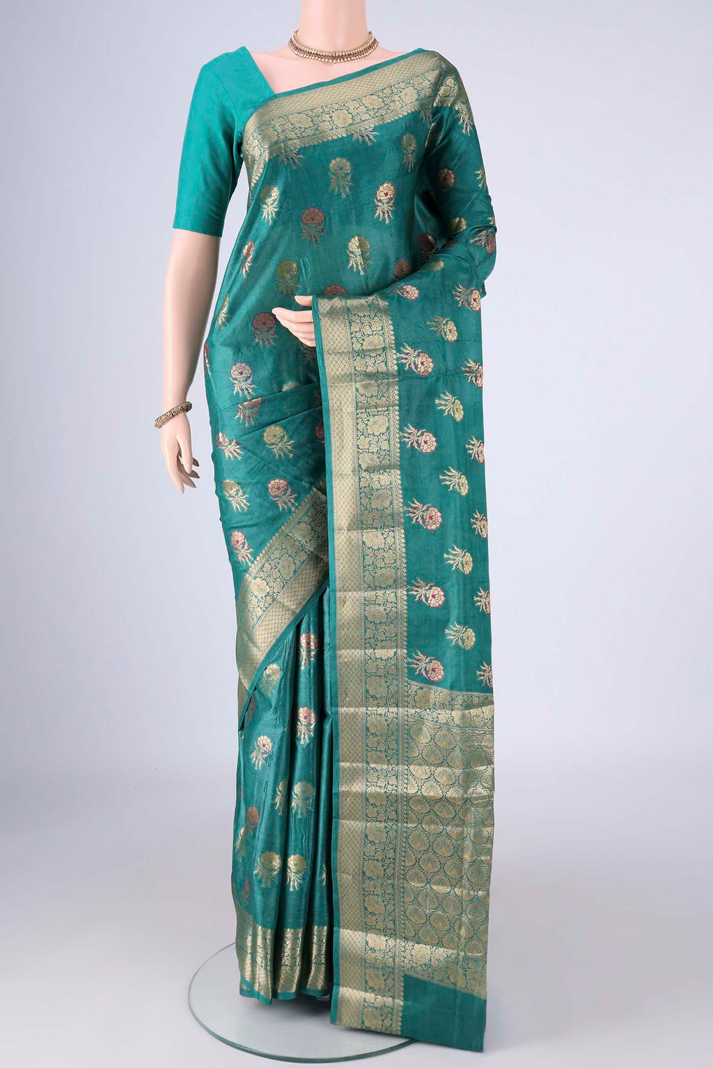 Sea Green Banarasi Tussar Silk Saree with Zari And Thread Butta on the body and Zari Border.  displayed on a mannequin