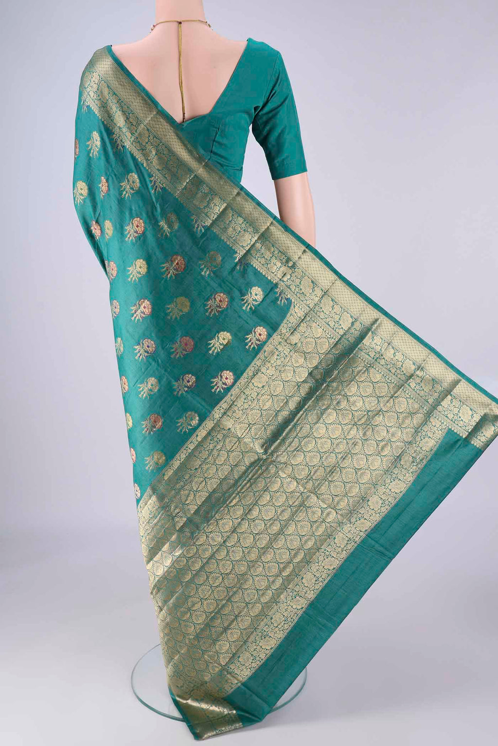 Flat view of Sea Green Banarasi Tussar Silk Saree with Zari And Thread Butta on the body and Zari Border. 