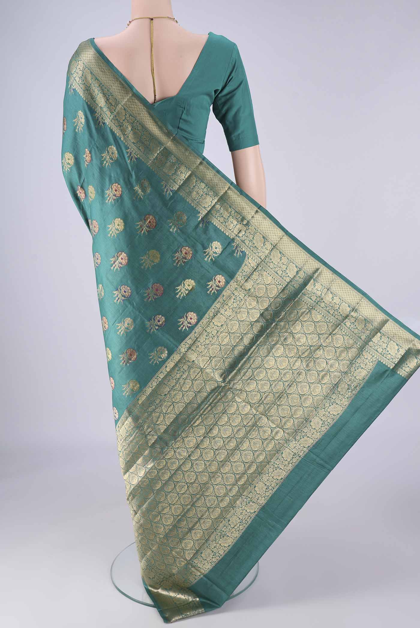 Flat view of Sea Green Banarasi Tussar Silk Saree with Zari And Thread Butta on the body and Zari Border. 