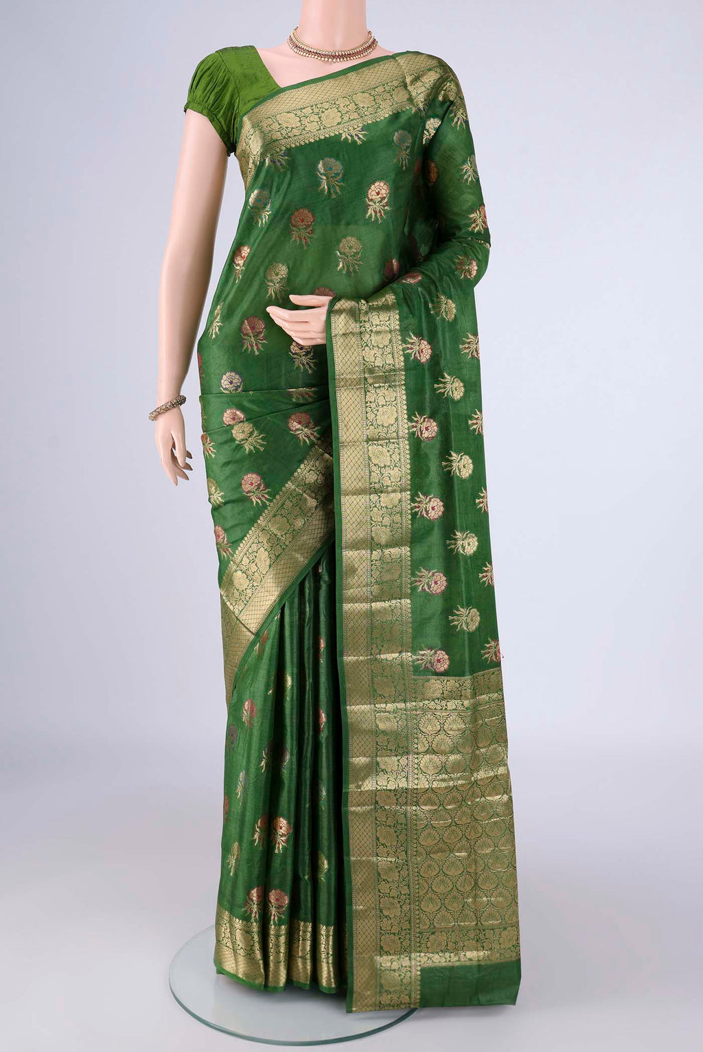 Green Banarasi Tussar Silk Saree with Zari And Thread Butta on the body and Zari Border.  displayed on a mannequin