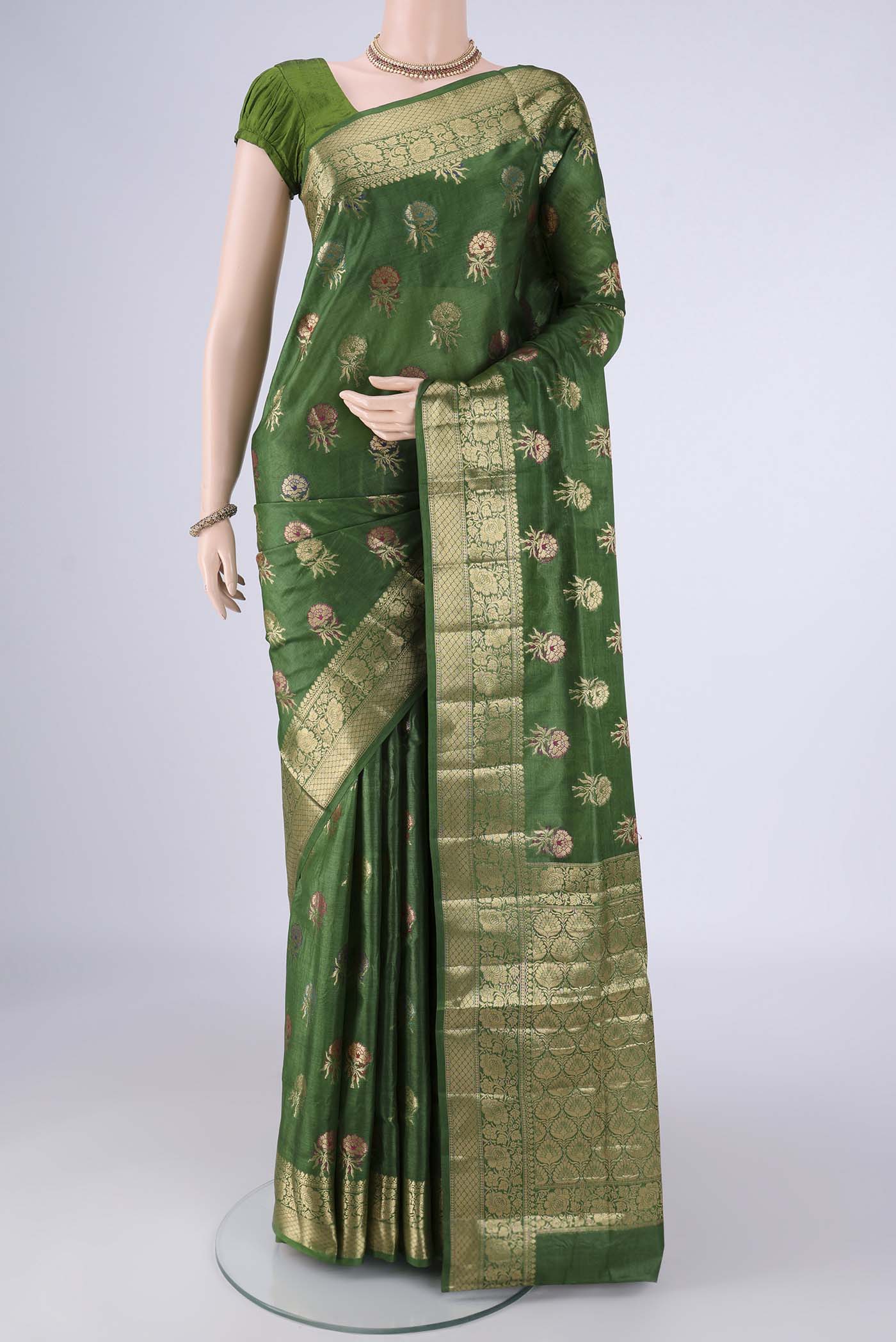 Green Banarasi Tussar Silk Saree with Zari And Thread Butta on the body and Zari Border.  displayed on a mannequin