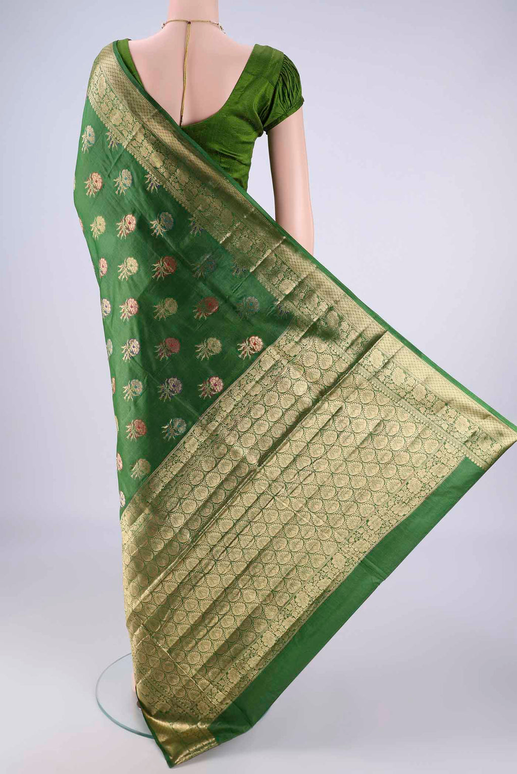 Flat view of Green Banarasi Tussar Silk Saree with Zari And Thread Butta on the body and Zari Border. 