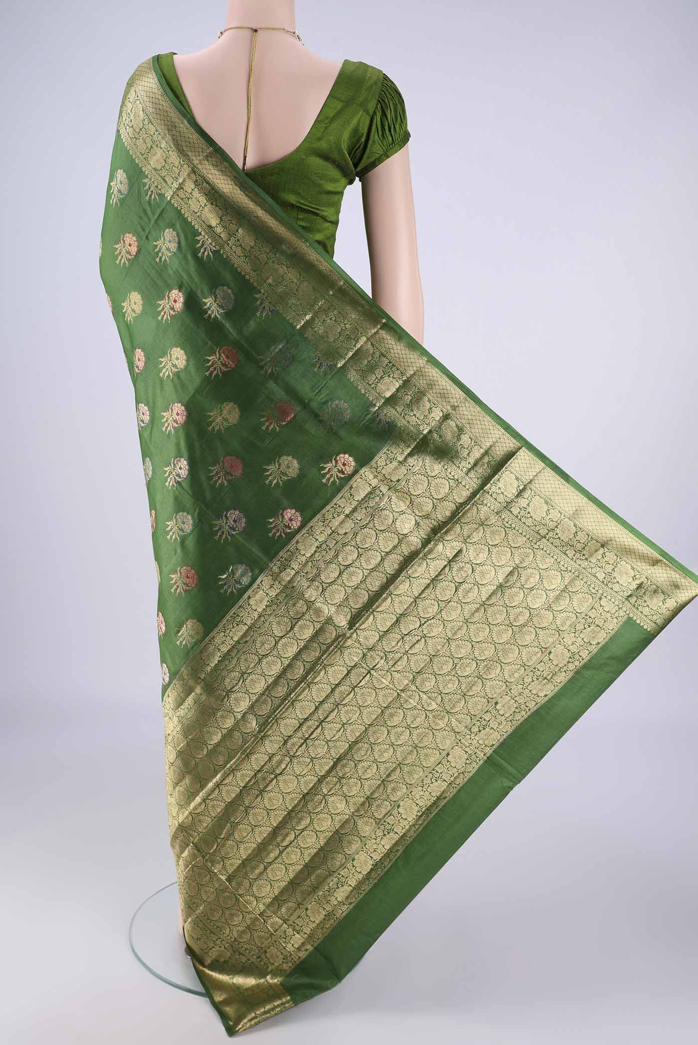 Flat view of Green Banarasi Tussar Silk Saree with Zari And Thread Butta on the body and Zari Border. 