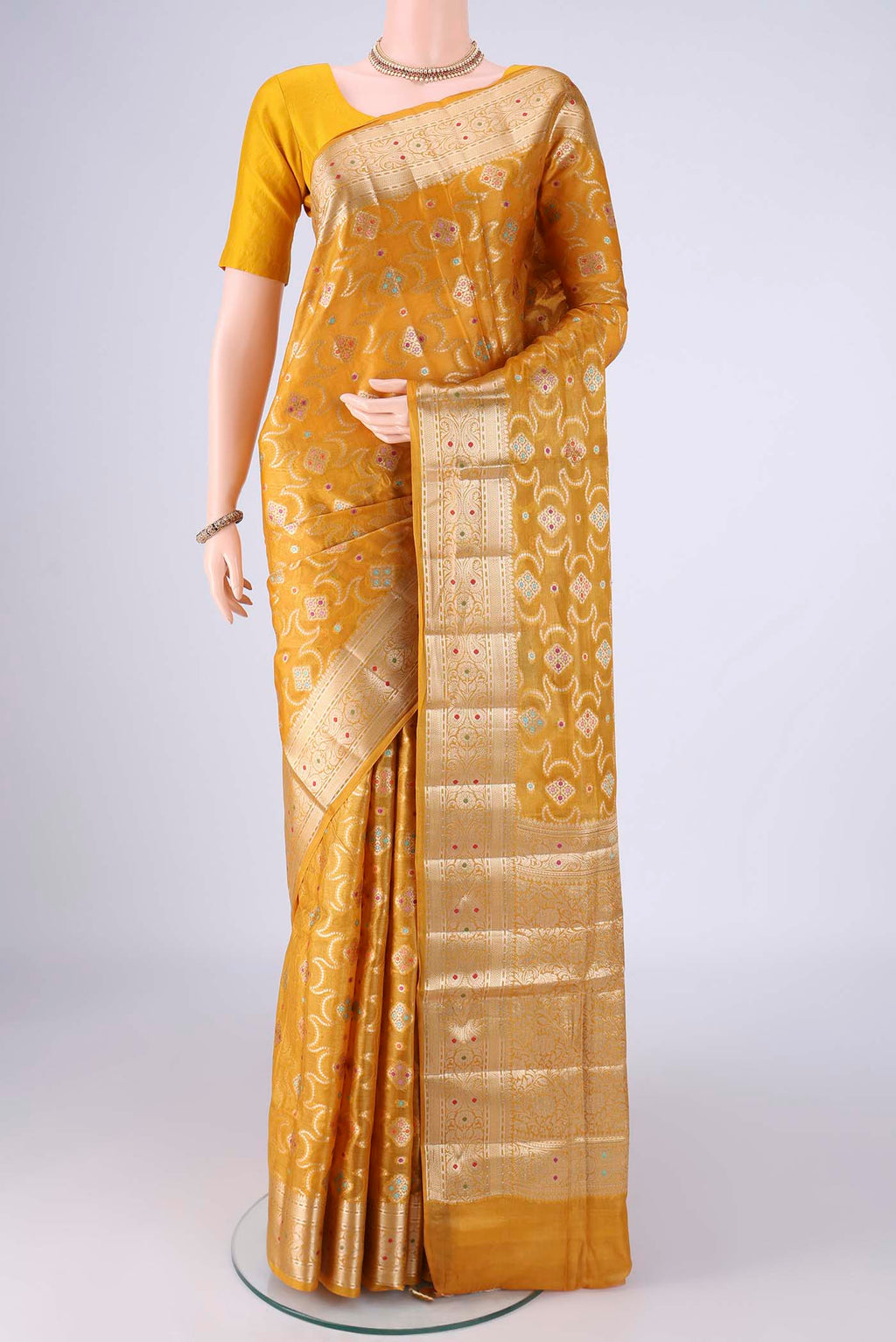Mustard Banarasi Tussar Silk Saree with Zari And Thread Butta on the body and Zari Border.  displayed on a mannequin