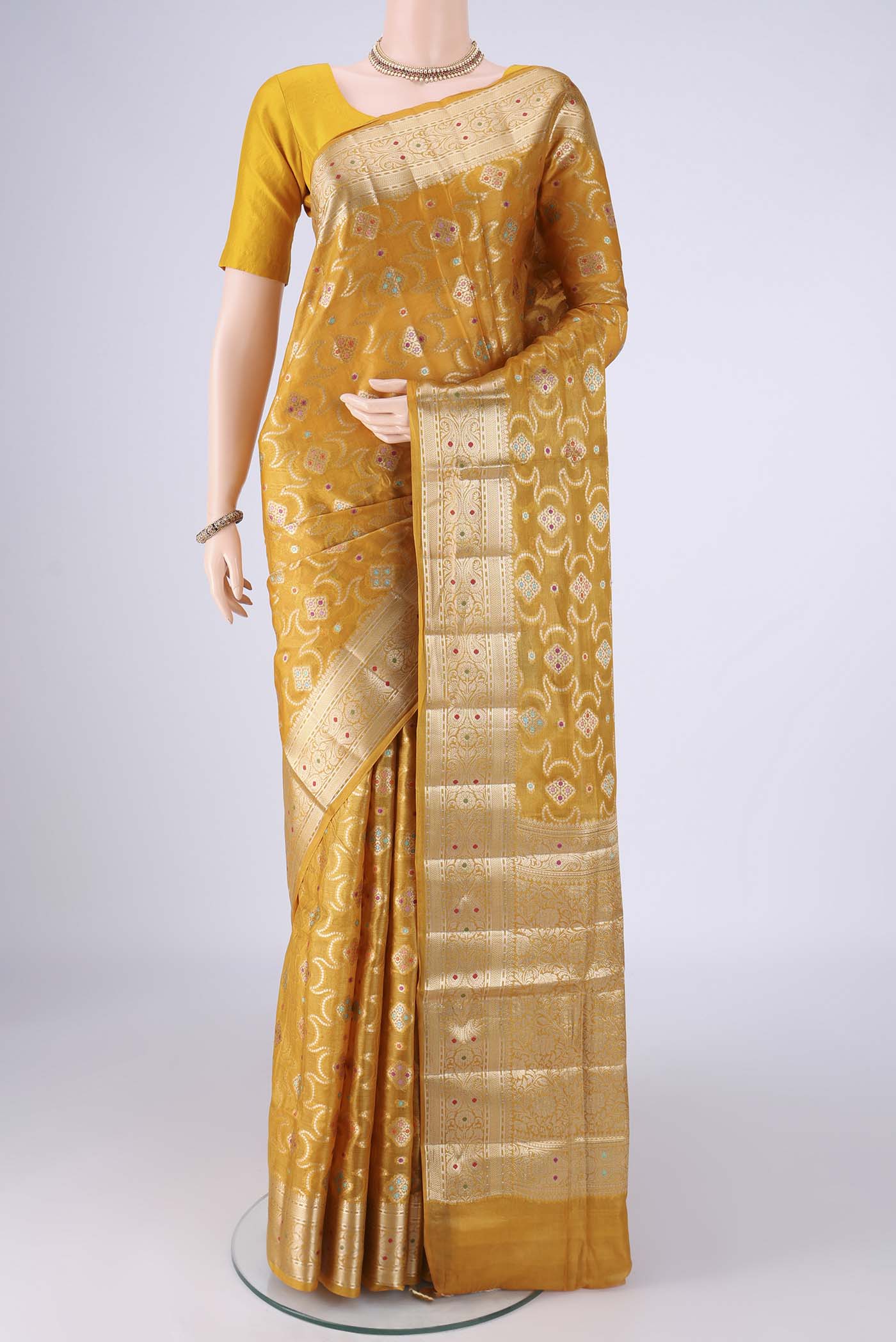 Mustard Banarasi Tussar Silk Saree with Zari And Thread Butta on the body and Zari Border.  displayed on a mannequin