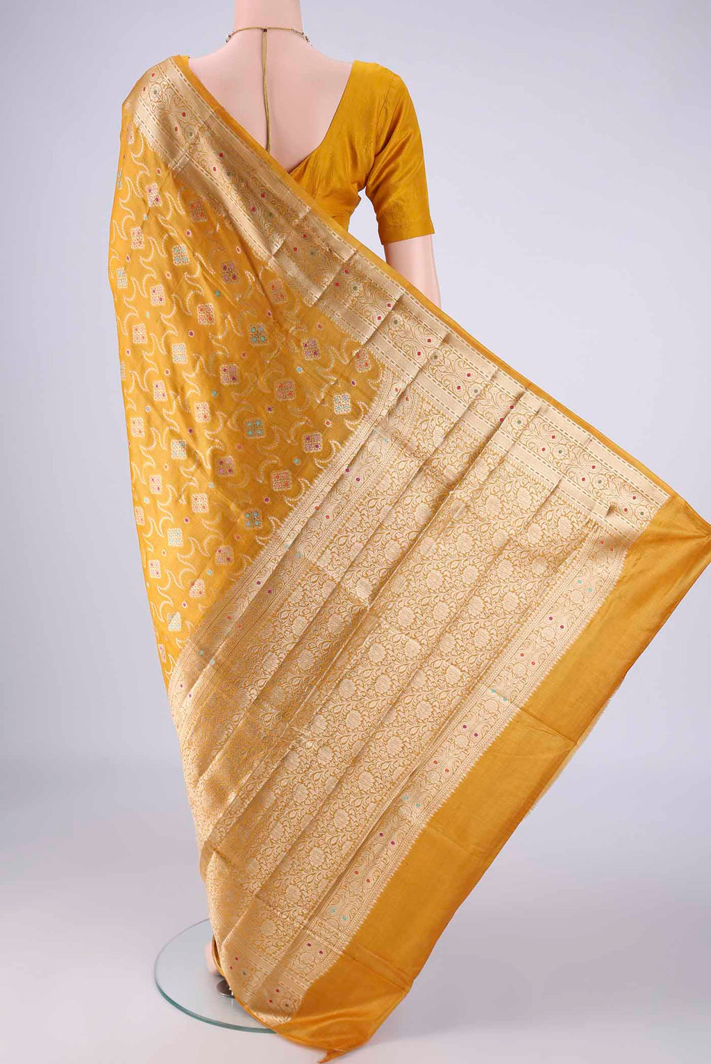 Flat view of Mustard Banarasi Tussar Silk Saree with Zari And Thread Butta on the body and Zari Border. 