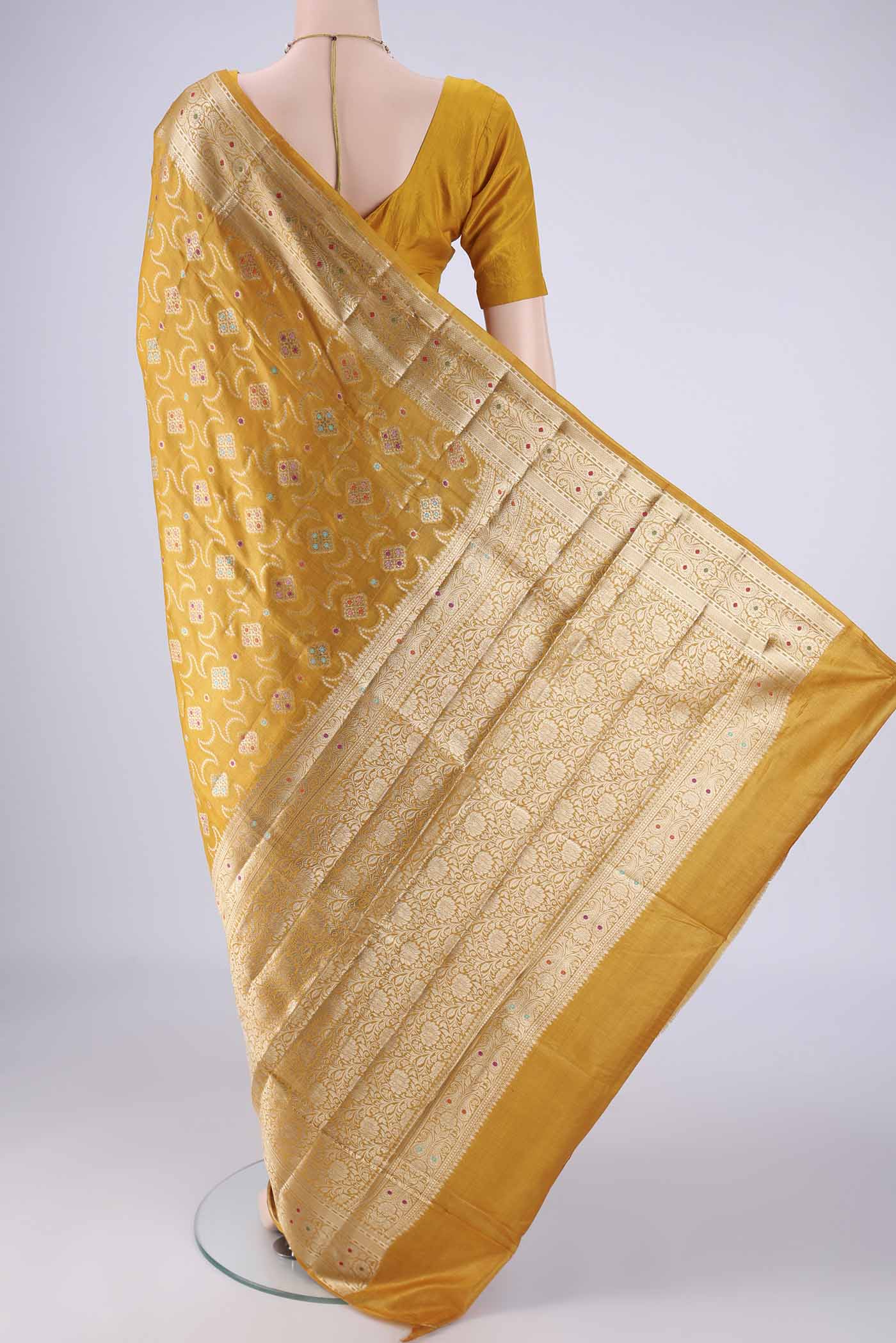 Flat view of Mustard Banarasi Tussar Silk Saree with Zari And Thread Butta on the body and Zari Border. 
