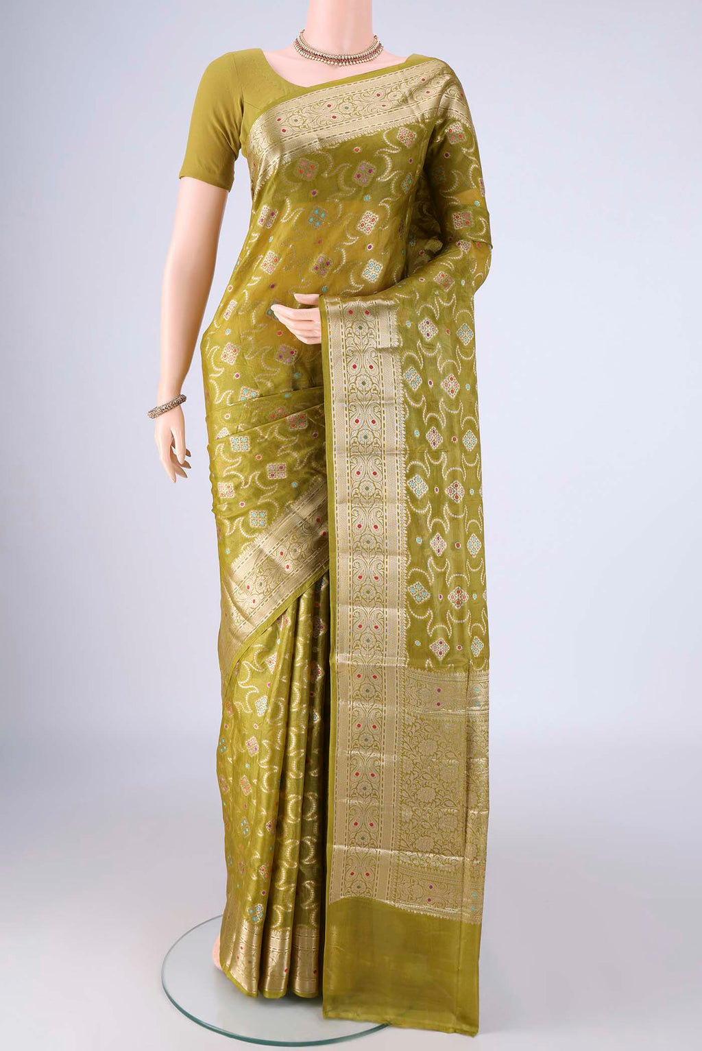 Light Green Banarasi Tussar Silk Saree with Zari And Thread Butta on the body and Zari Border.  displayed on a mannequin