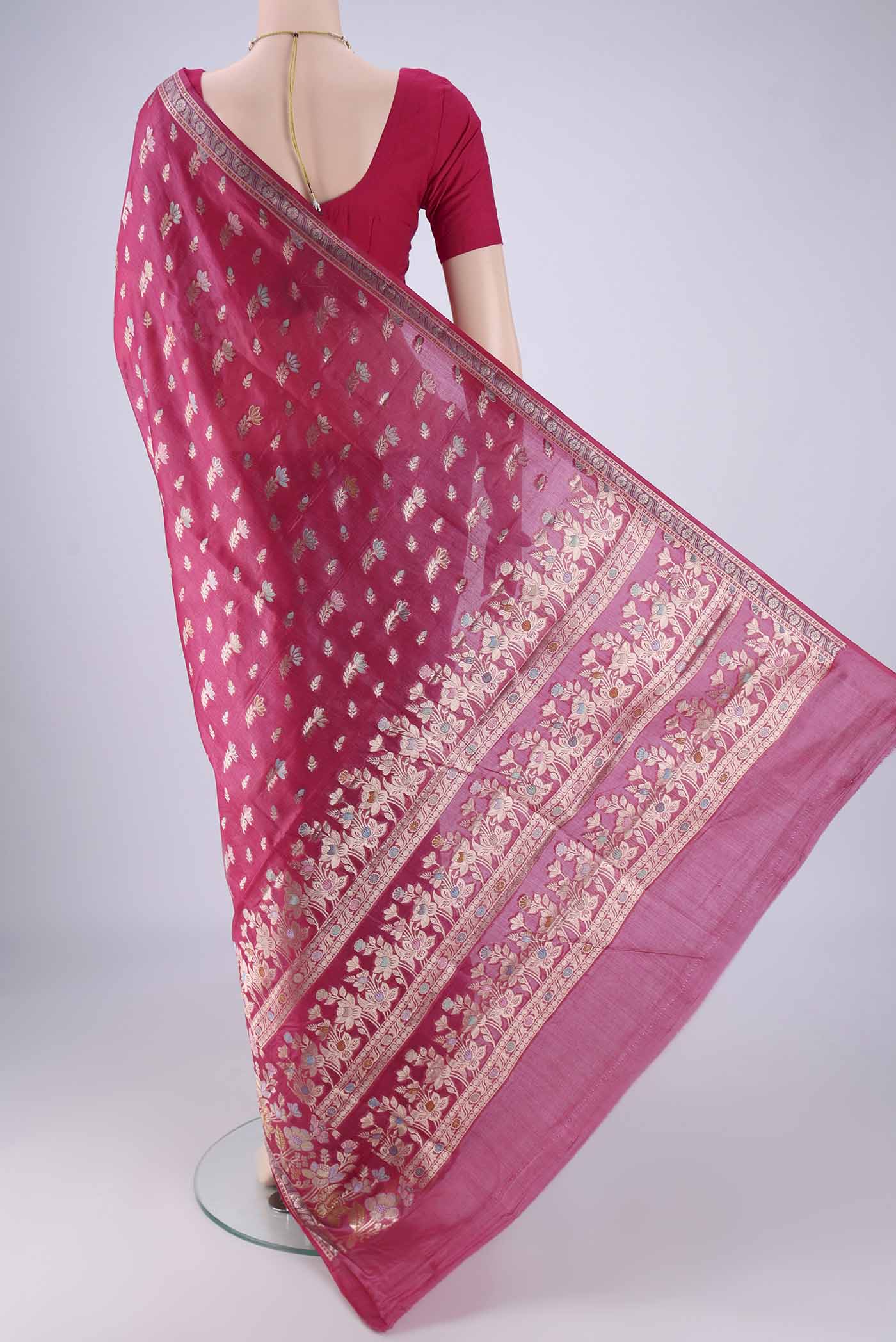 Flat view of Rani Pink Banarasi Tussar Silk Saree with Zari And Thread Butta on the body and Zari Border. 