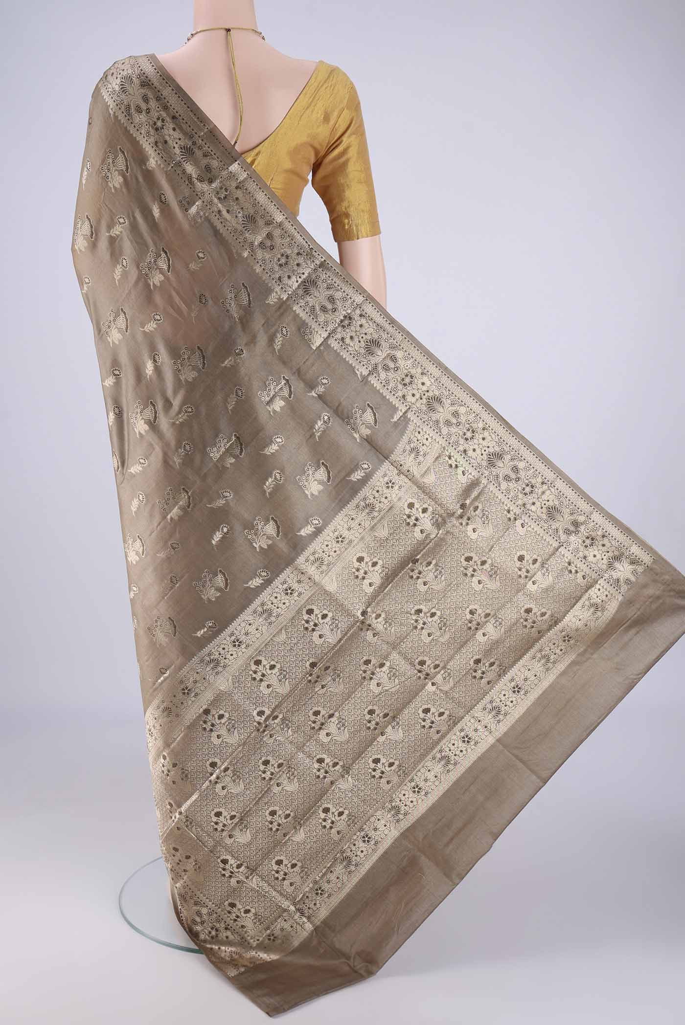 Flat view of Dark Beige Banarasi Tussar Silk Saree with Zari And Thread Butta on the body and Zari Border. 