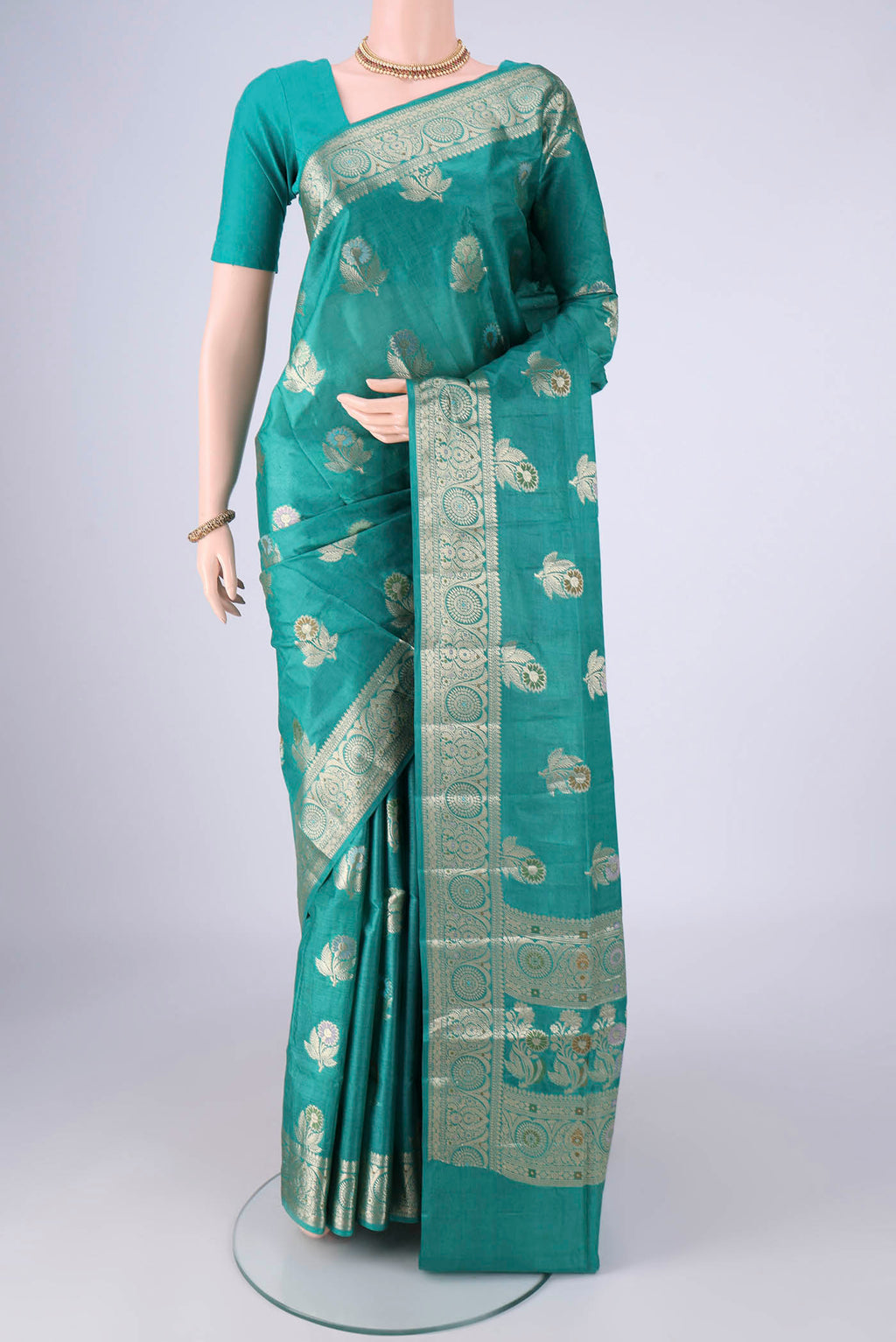 Turquoise Banarasi Tussar Silk Saree with Zari And Thread Butta on the body and Zari Border.  displayed on a mannequin