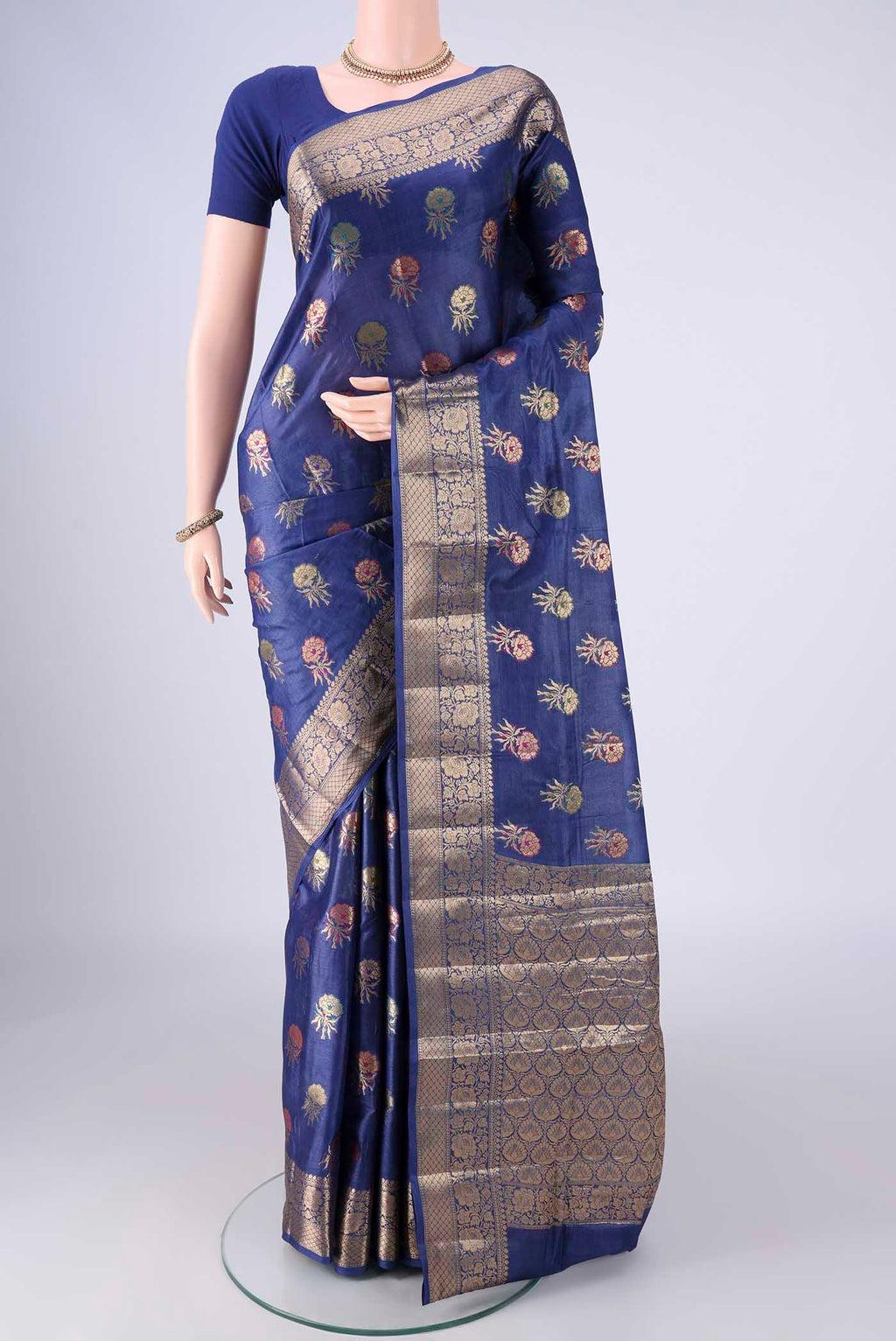 Blue Banarasi Tussar Silk Saree with Zari And Thread Butta on the body and Zari Border.  displayed on a mannequin