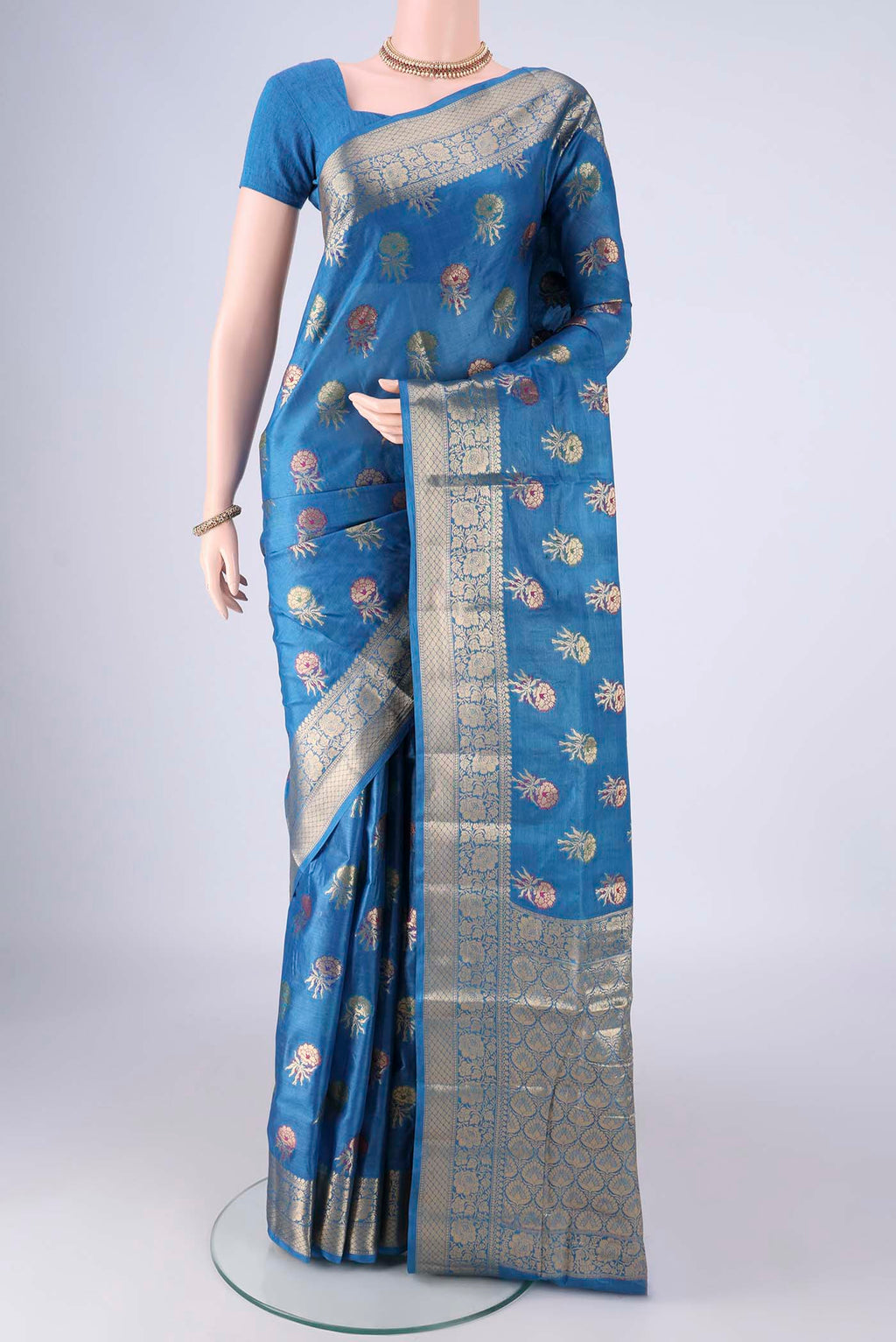 Blue Banarasi Tussar Silk Saree with Zari And Thread Butta on the body and Zari Border.  displayed on a mannequin