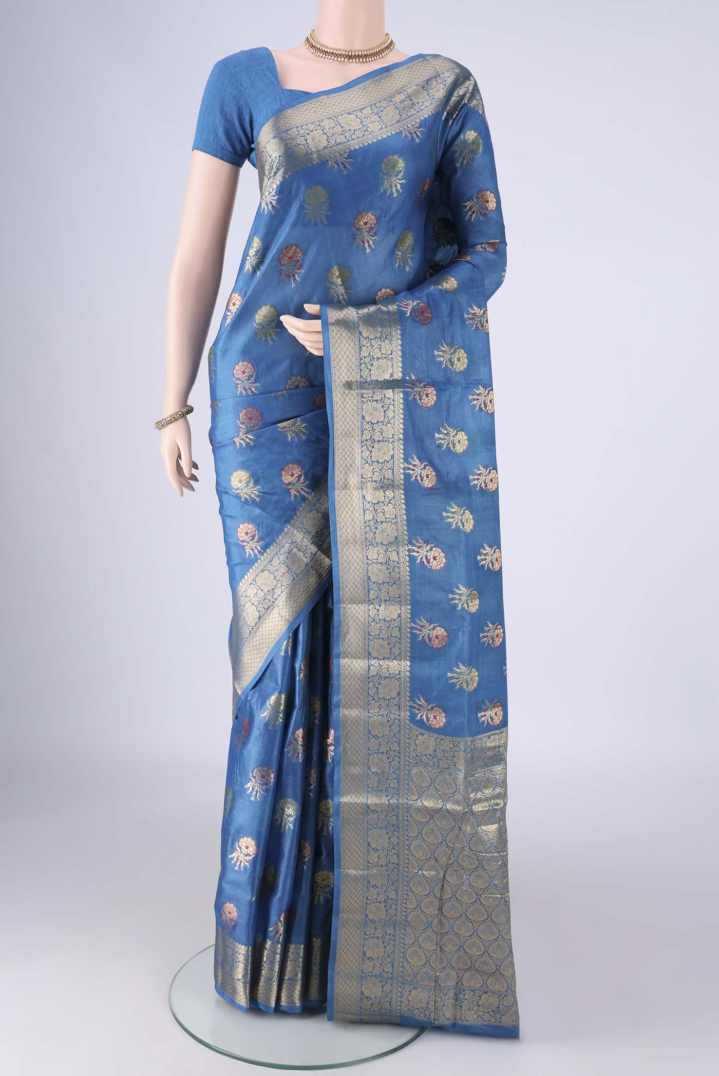 Blue Banarasi Tussar Silk Saree with Zari And Thread Butta on the body and Zari Border.  displayed on a mannequin