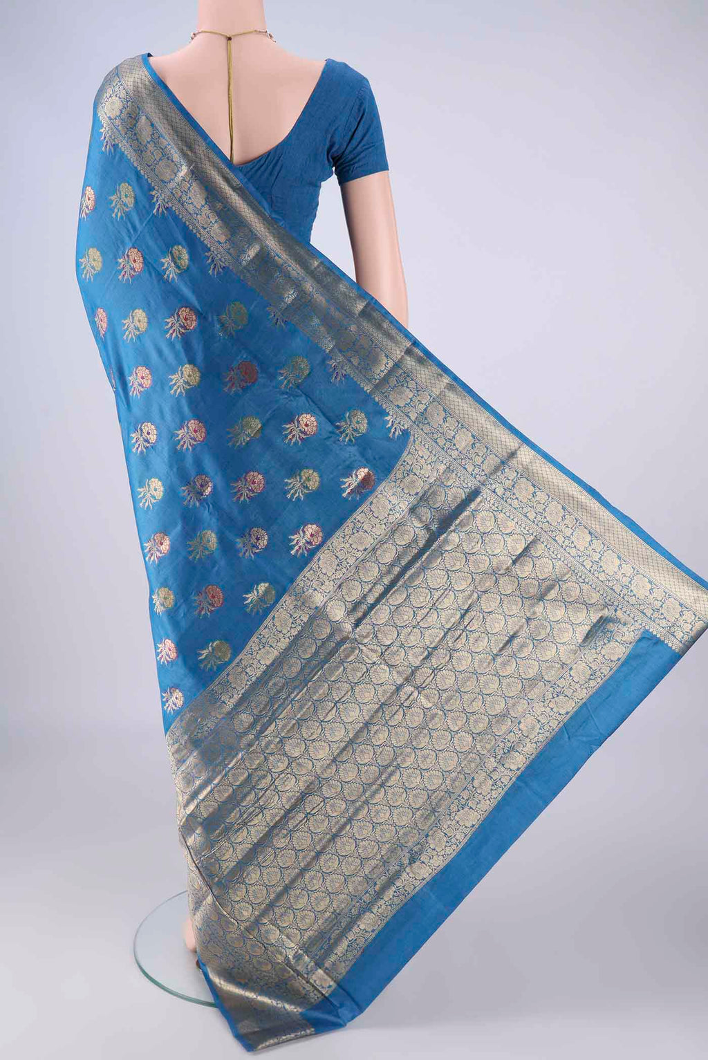 Flat view of Blue Banarasi Tussar Silk Saree with Zari And Thread Butta on the body and Zari Border. 
