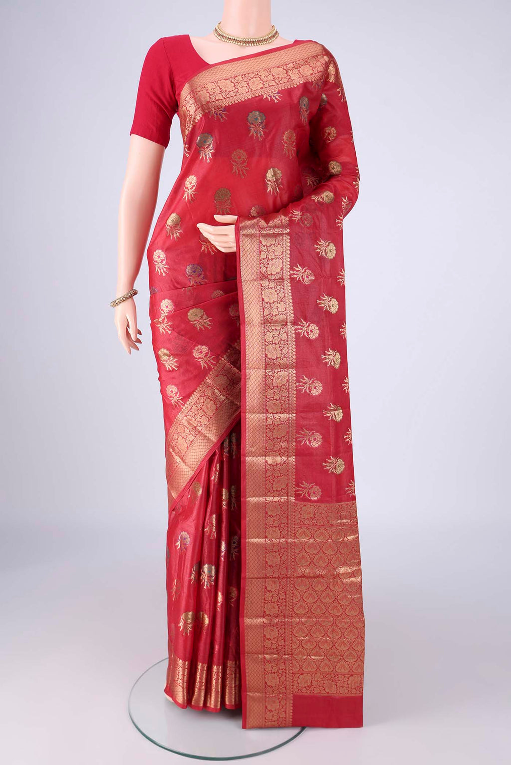 Red Banarasi Tussar Silk Saree with Zari And Thread Butta on the body and Zari Border.  displayed on a mannequin