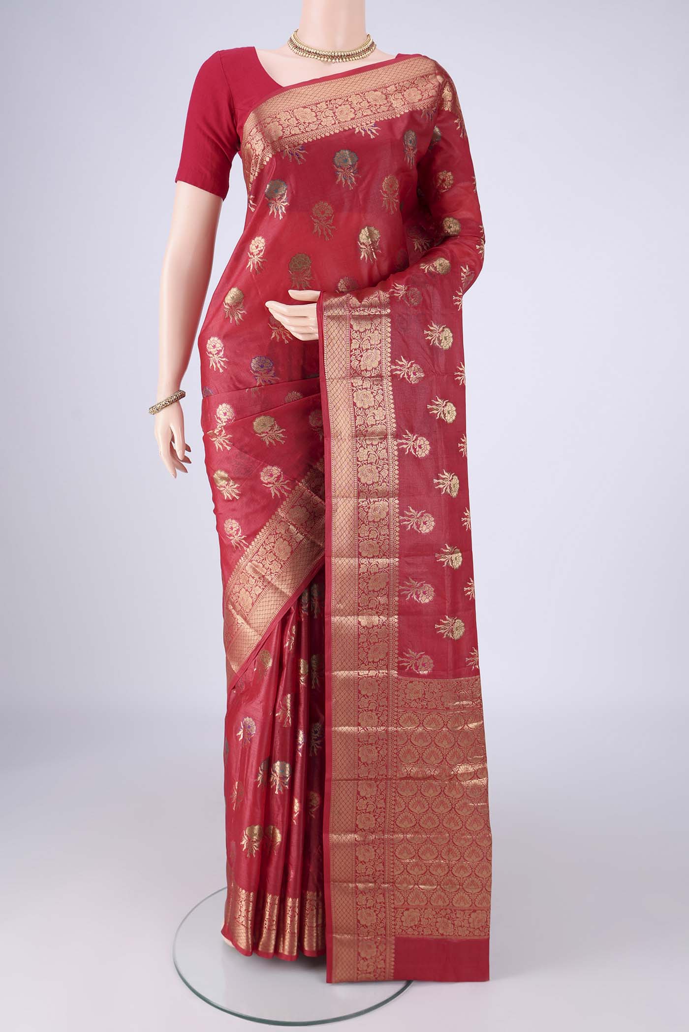 Red Banarasi Tussar Silk Saree with Zari And Thread Butta on the body and Zari Border.  displayed on a mannequin