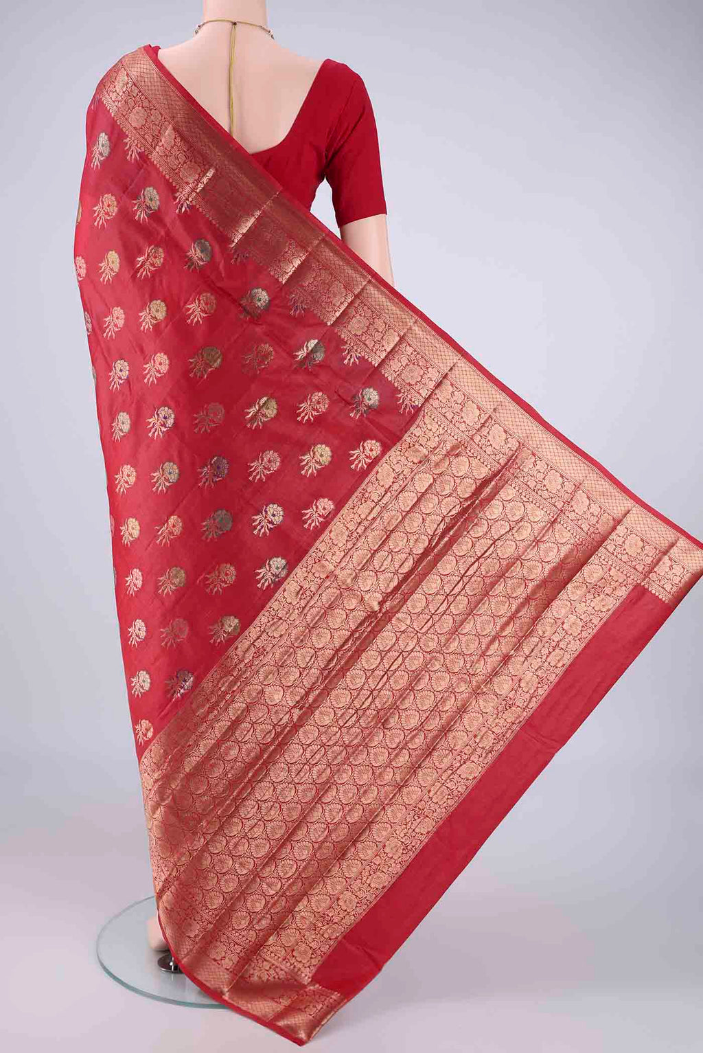 Flat view of Red Banarasi Tussar Silk Saree with Zari And Thread Butta on the body and Zari Border. 