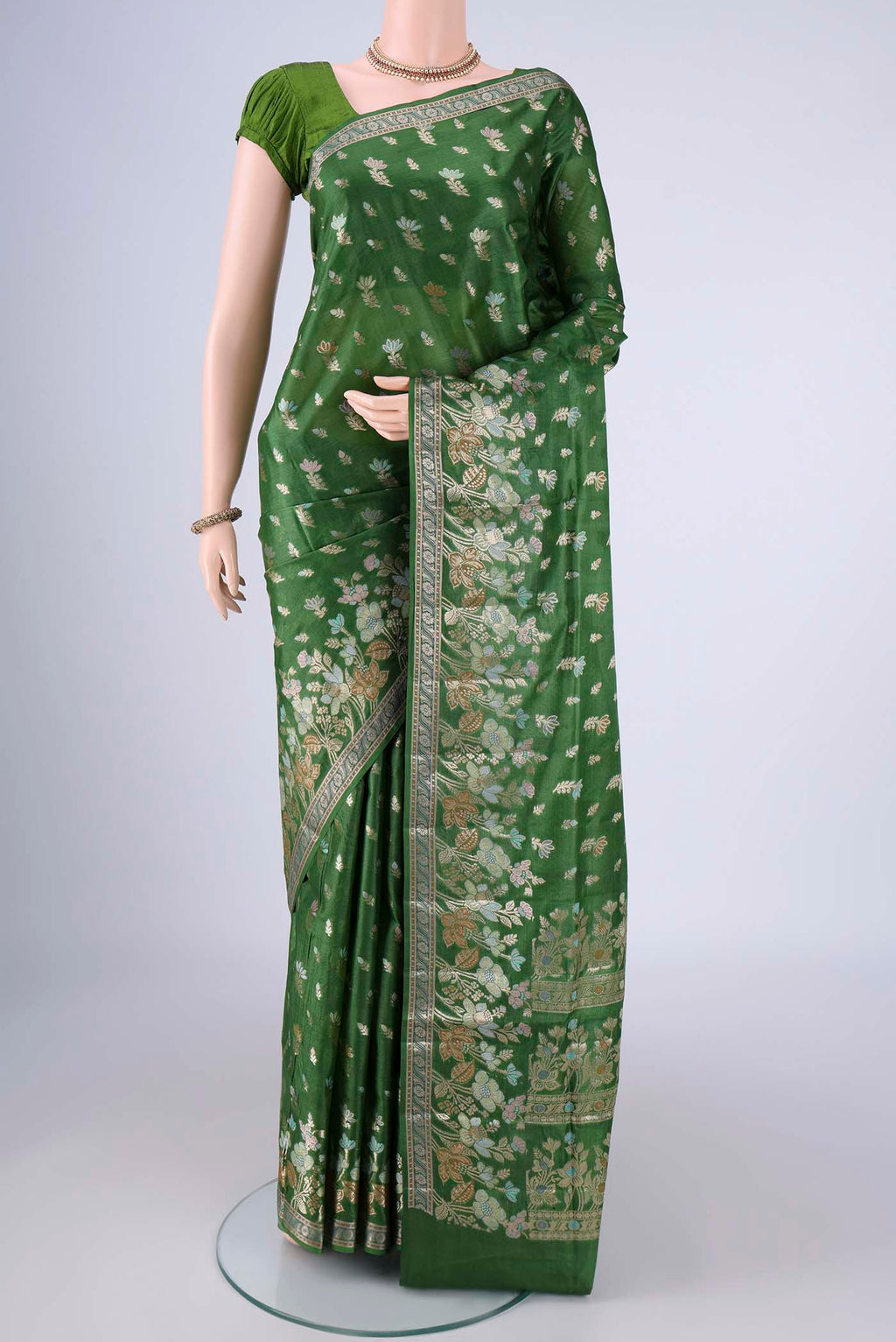 Green Banarasi Tussar Silk Saree with Zari And Thread Butta on the body and Zari Border.  displayed on a mannequin
