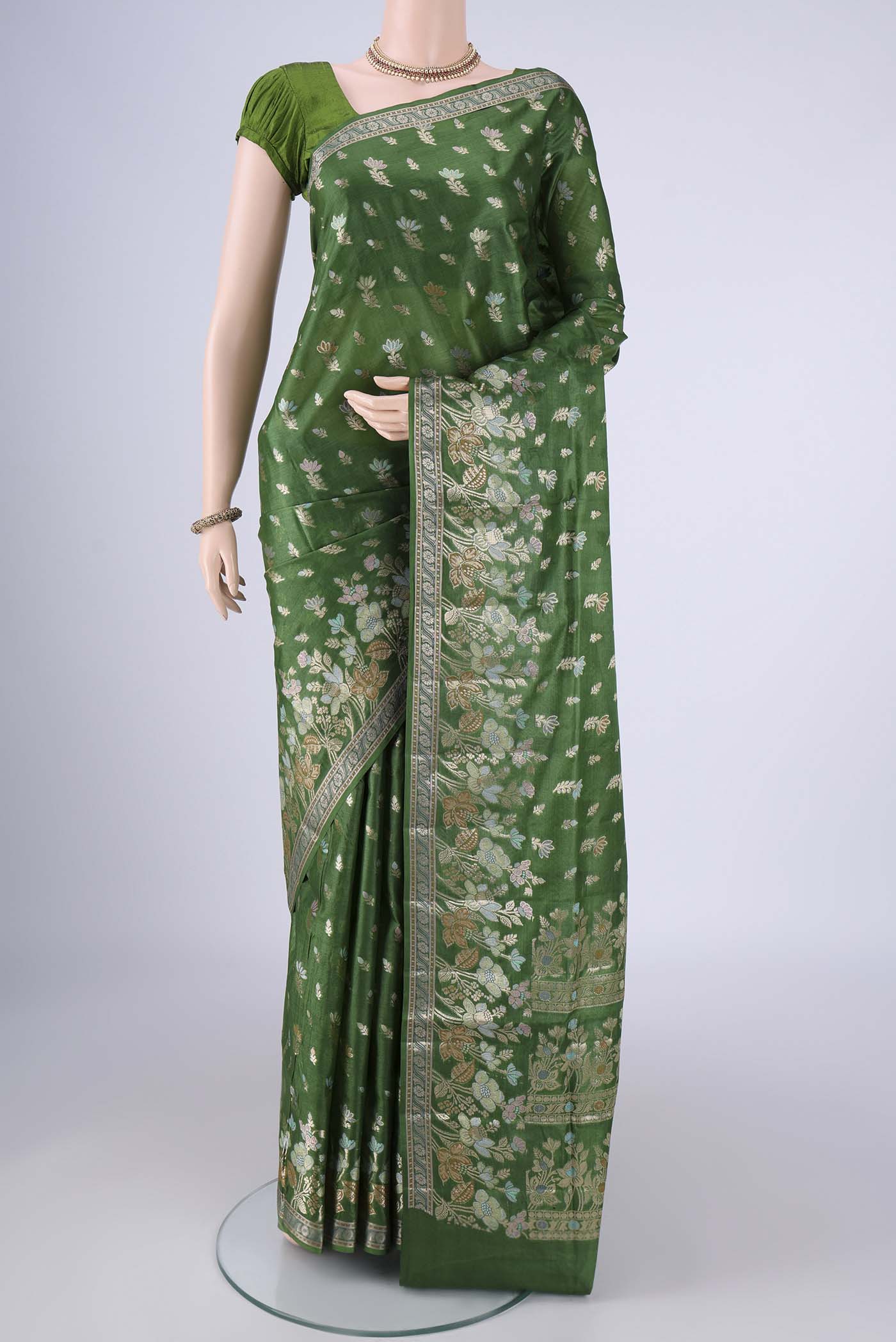 Green Banarasi Tussar Silk Saree with Zari And Thread Butta on the body and Zari Border.  displayed on a mannequin