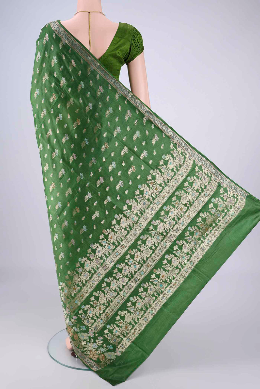Flat view of Green Banarasi Tussar Silk Saree with Zari And Thread Butta on the body and Zari Border. 