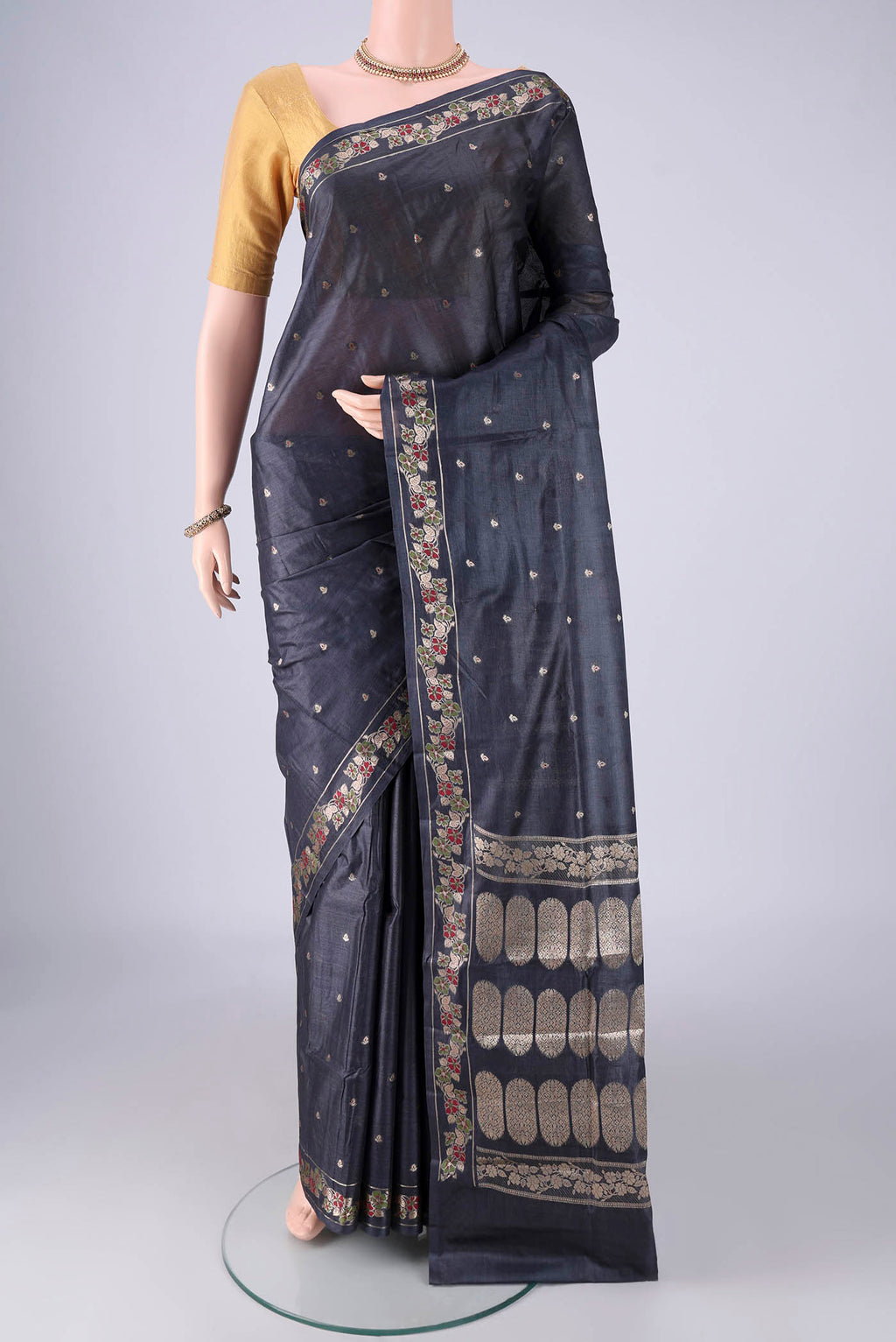 Davys Grey Banarasi Tussar Silk Saree with Zari And Thread Butta on the body and Zari Border.  displayed on a mannequin