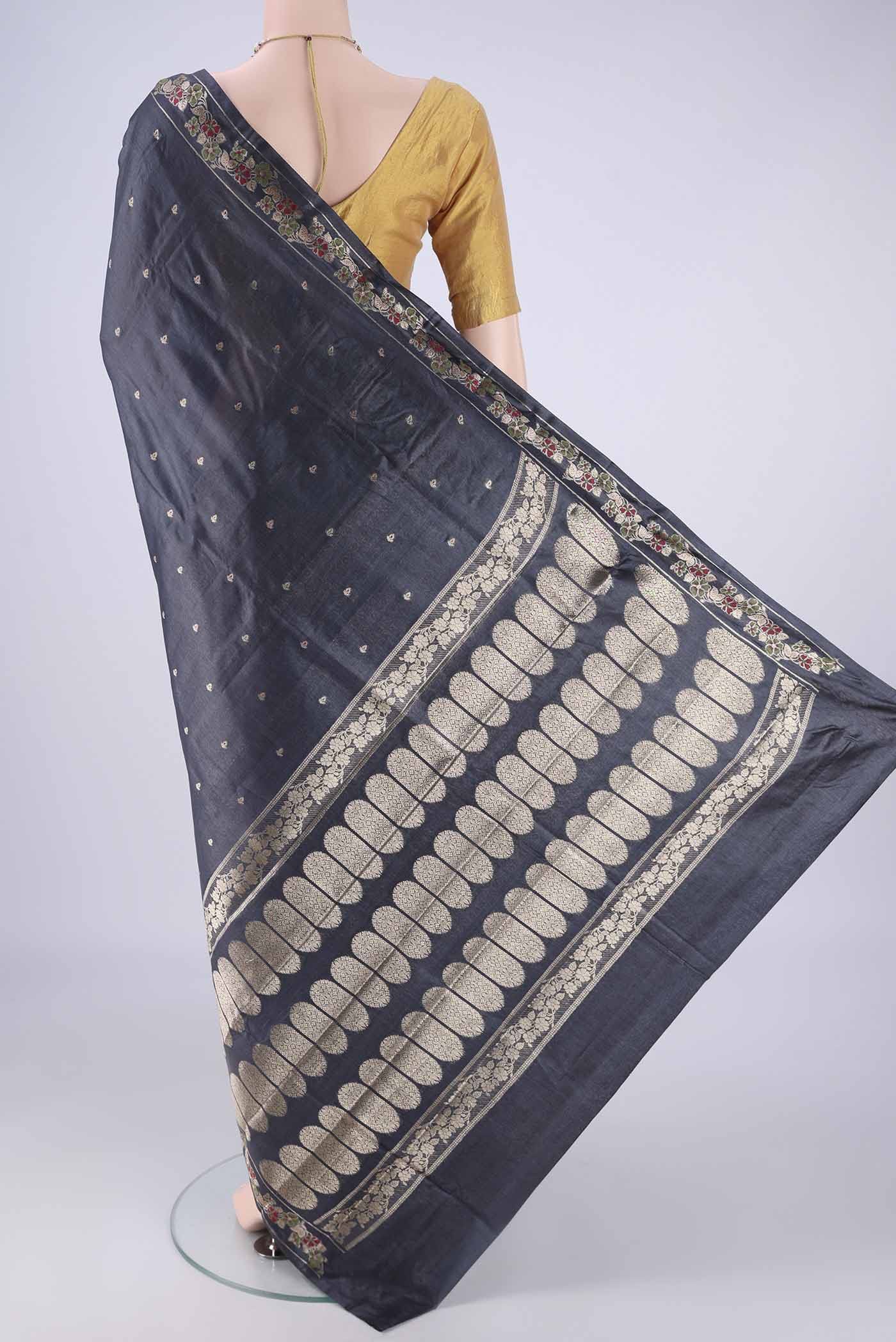Flat view of Davys Grey Banarasi Tussar Silk Saree with Zari And Thread Butta on the body and Zari Border. 