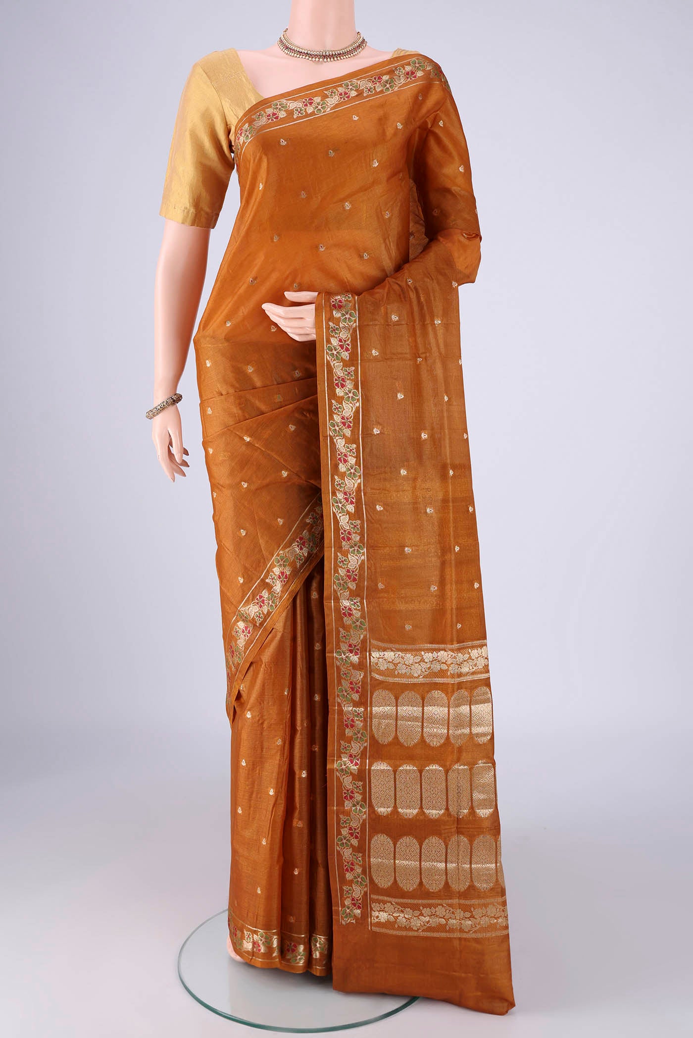 Mustard Banarasi Tussar Silk Saree with Zari And Thread Butta on the body and Zari Border.  displayed on a mannequin