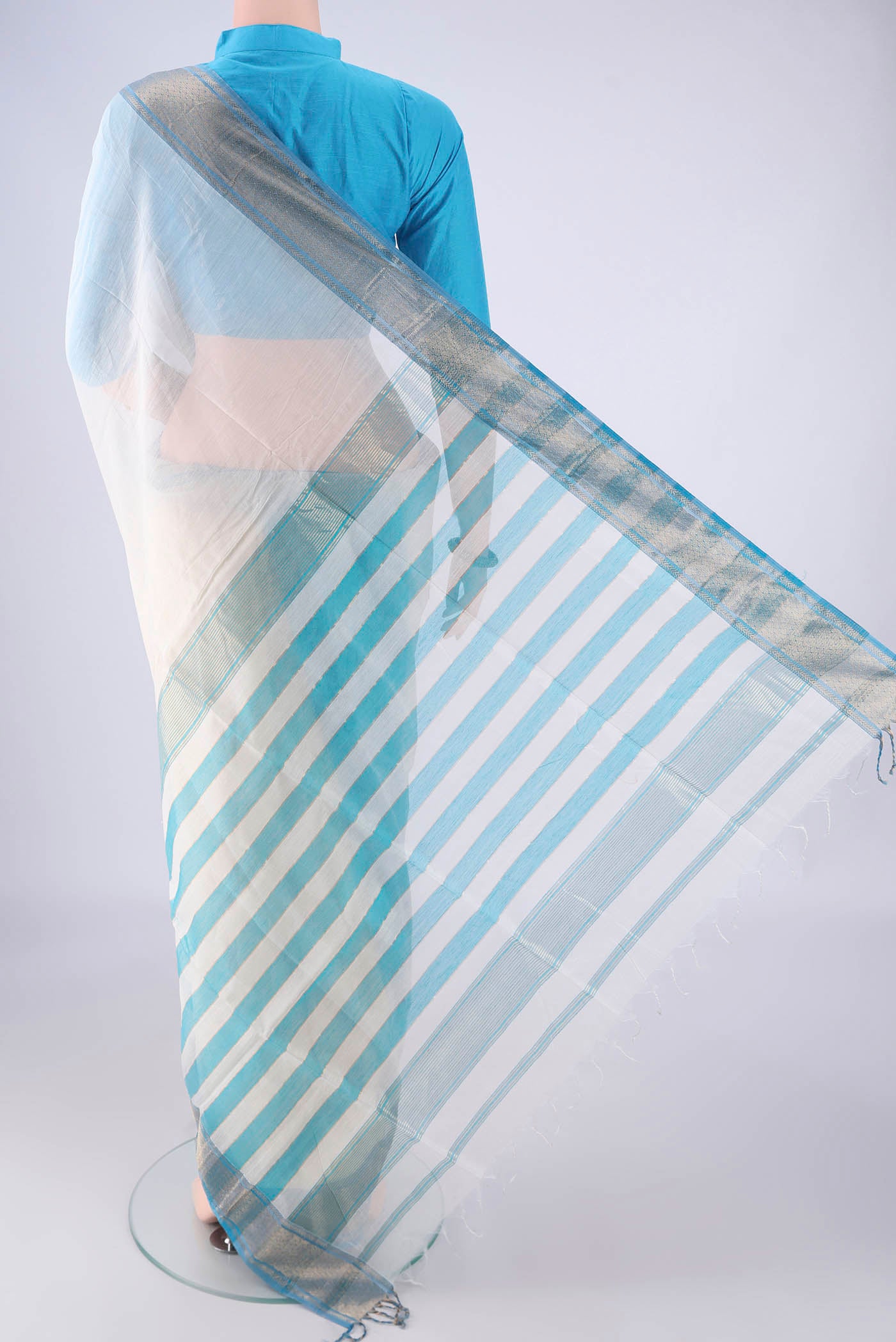 Flat view of White Maheshwari Silk Cotton Saree with Plain Body and Zari Border. 