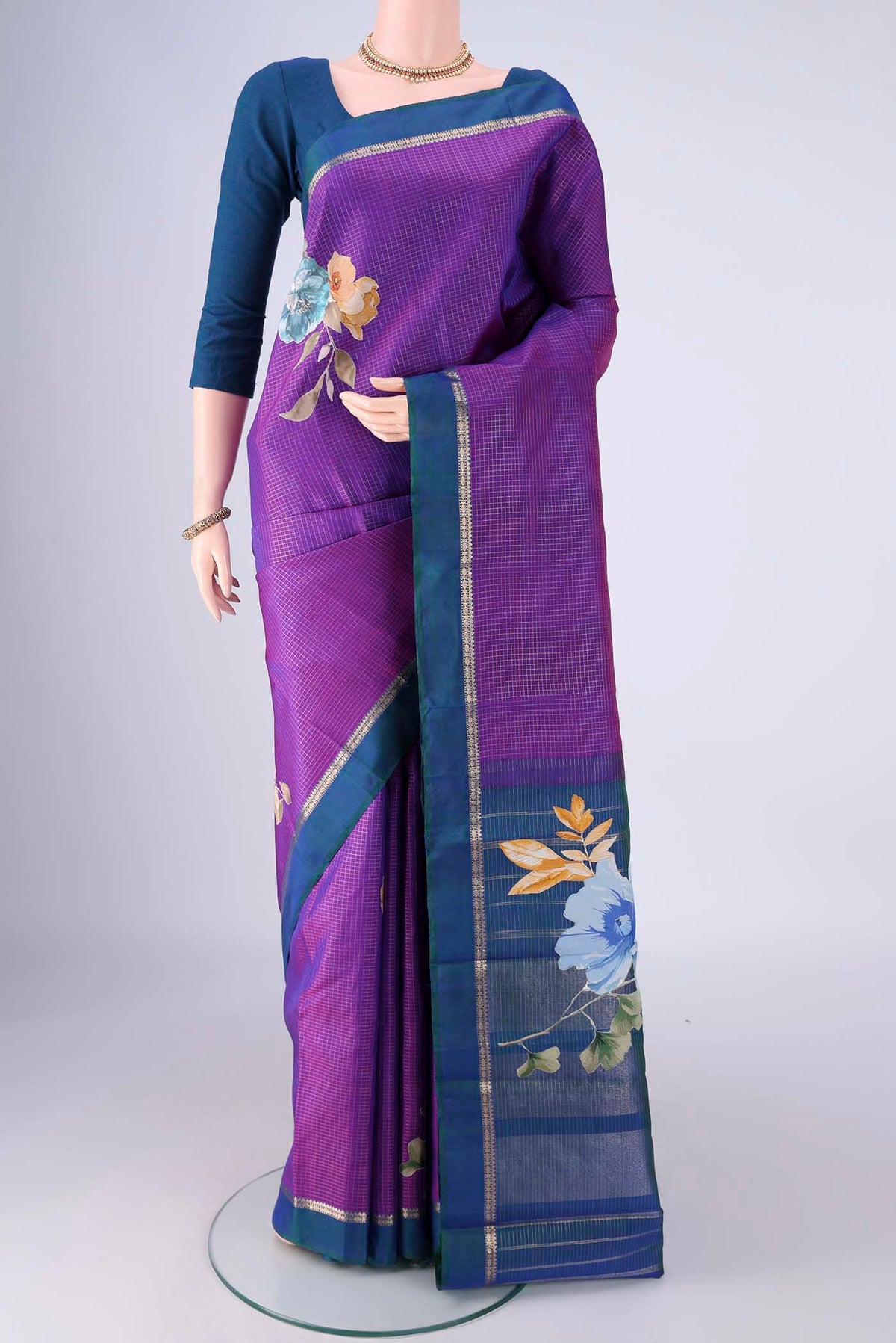 Purple Kanchipuram Silk Saree with Checked design on the body and Zari Border.  displayed on a mannequin