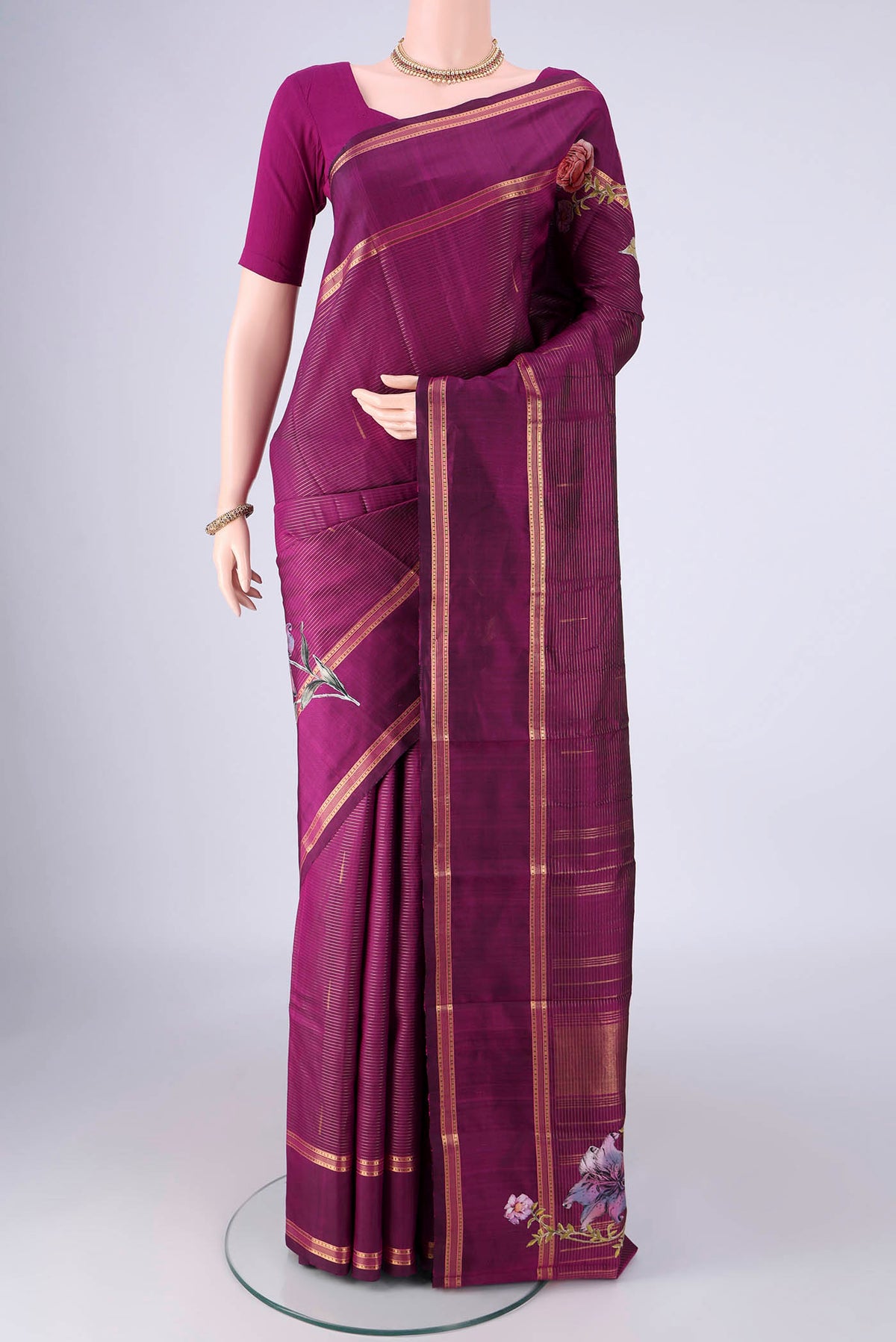 Purple Kanchipuram Silk Saree with Stripes on the body and Zari Border.  displayed on a mannequin