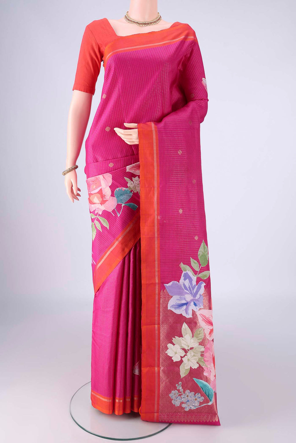 Rani Pink Kanchipuram Silk Saree with Checked design on the body and Zari Border.  displayed on a mannequin