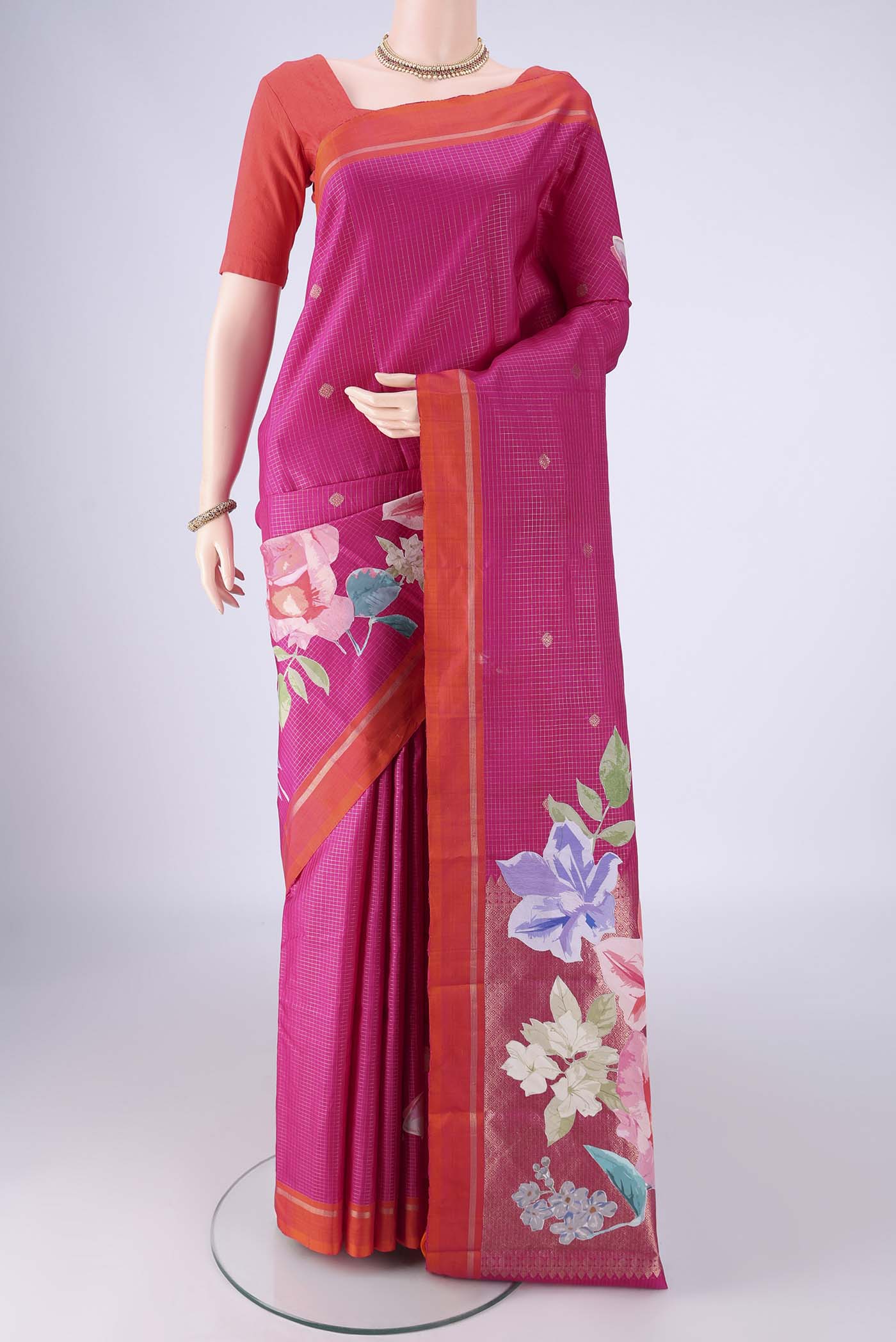 Rani Pink Kanchipuram Silk Saree with Checked design on the body and Zari Border.  displayed on a mannequin