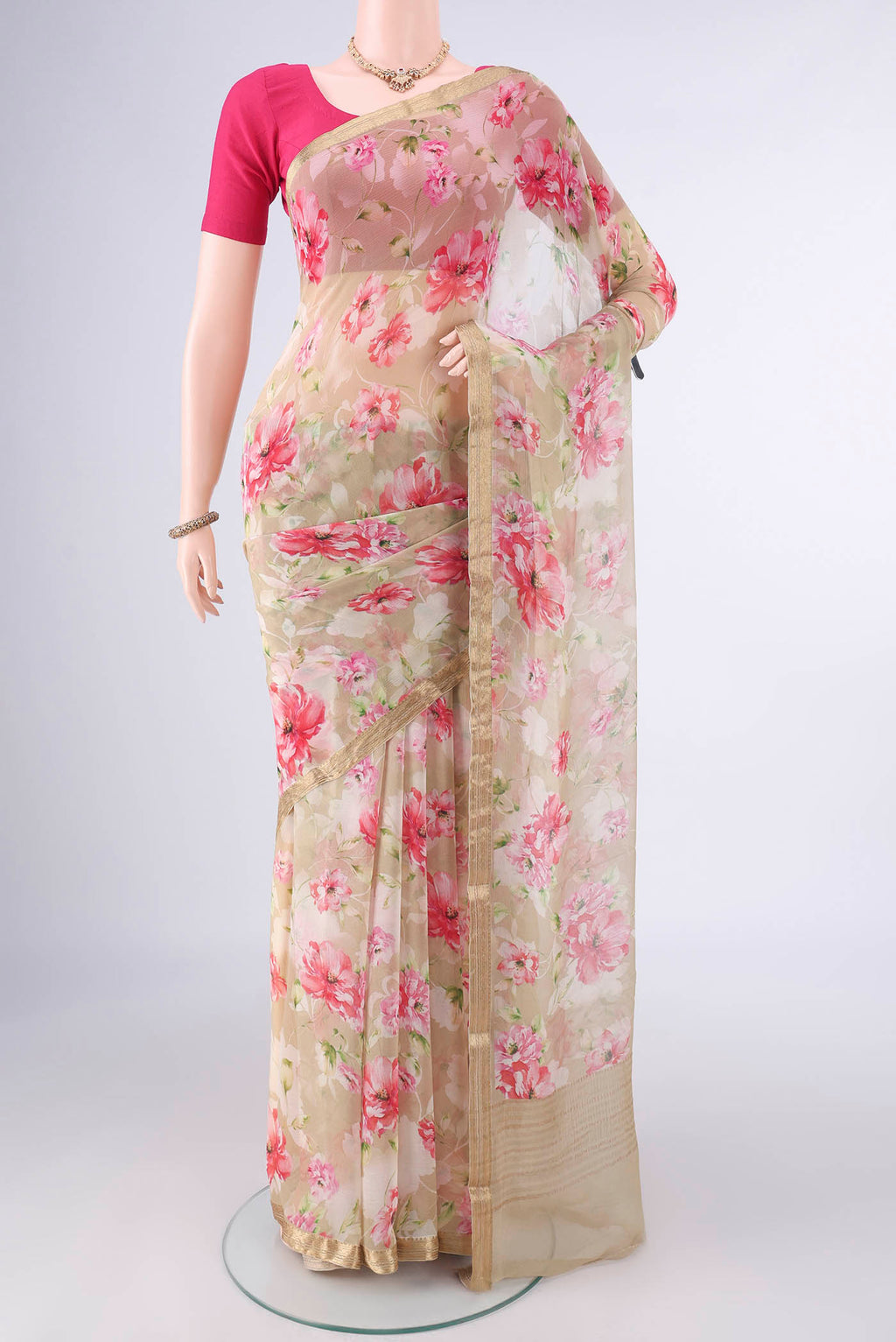 Beige Mysore Chiffon Saree with Floral Print on the body and Zari Border.  displayed on a mannequin