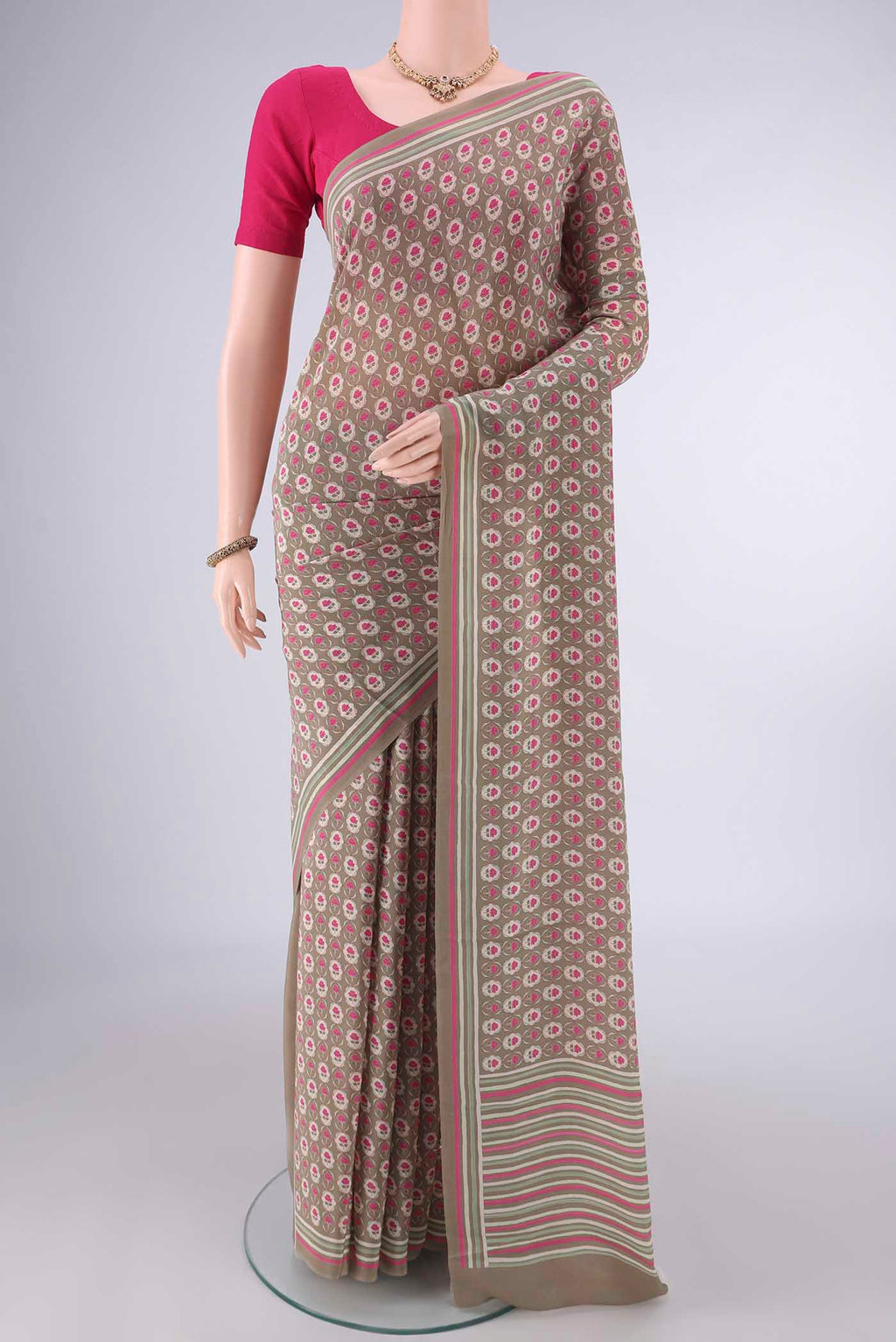 Beige Mysore Crepe Saree with Printed design on the body and Printed Border.  displayed on a mannequin
