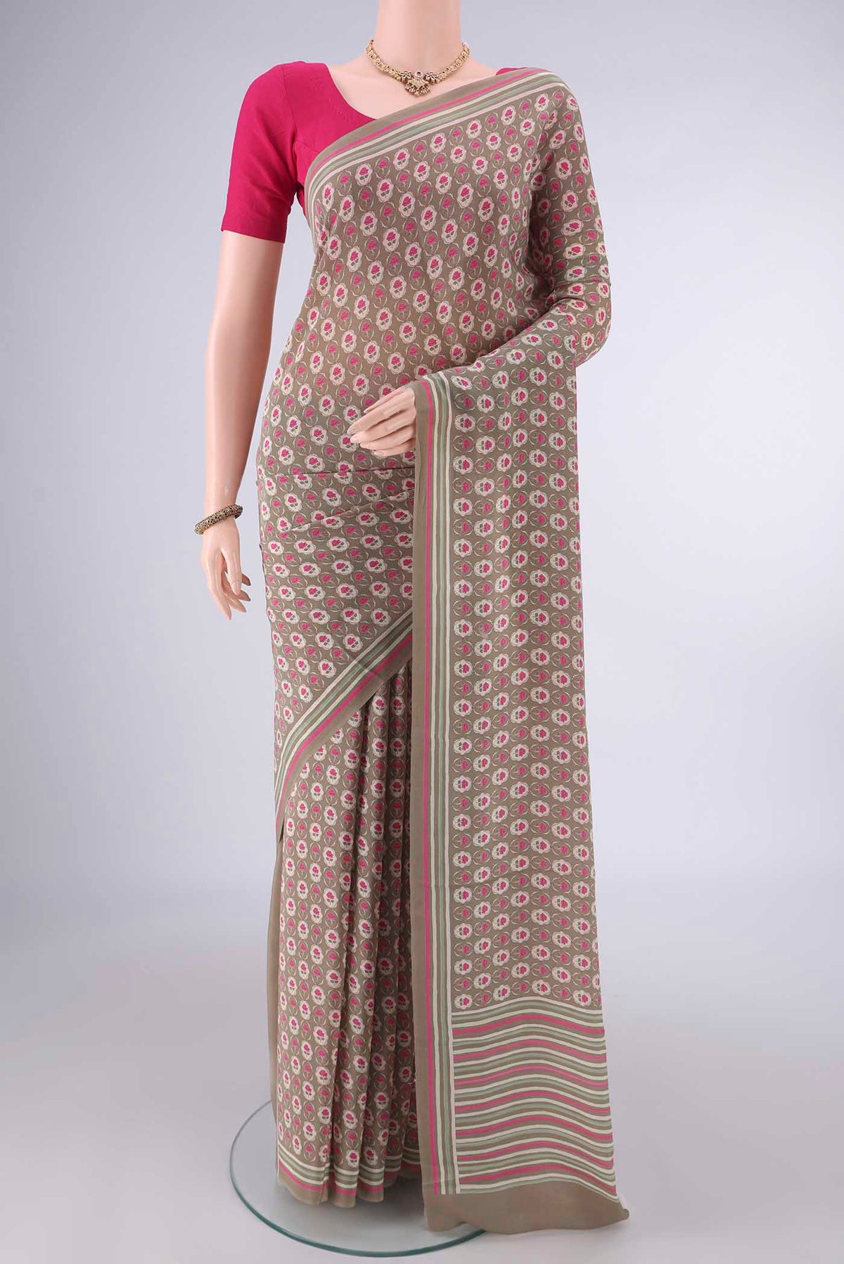 Beige Mysore Crepe Saree with Printed design on the body and Printed Border.  displayed on a mannequin