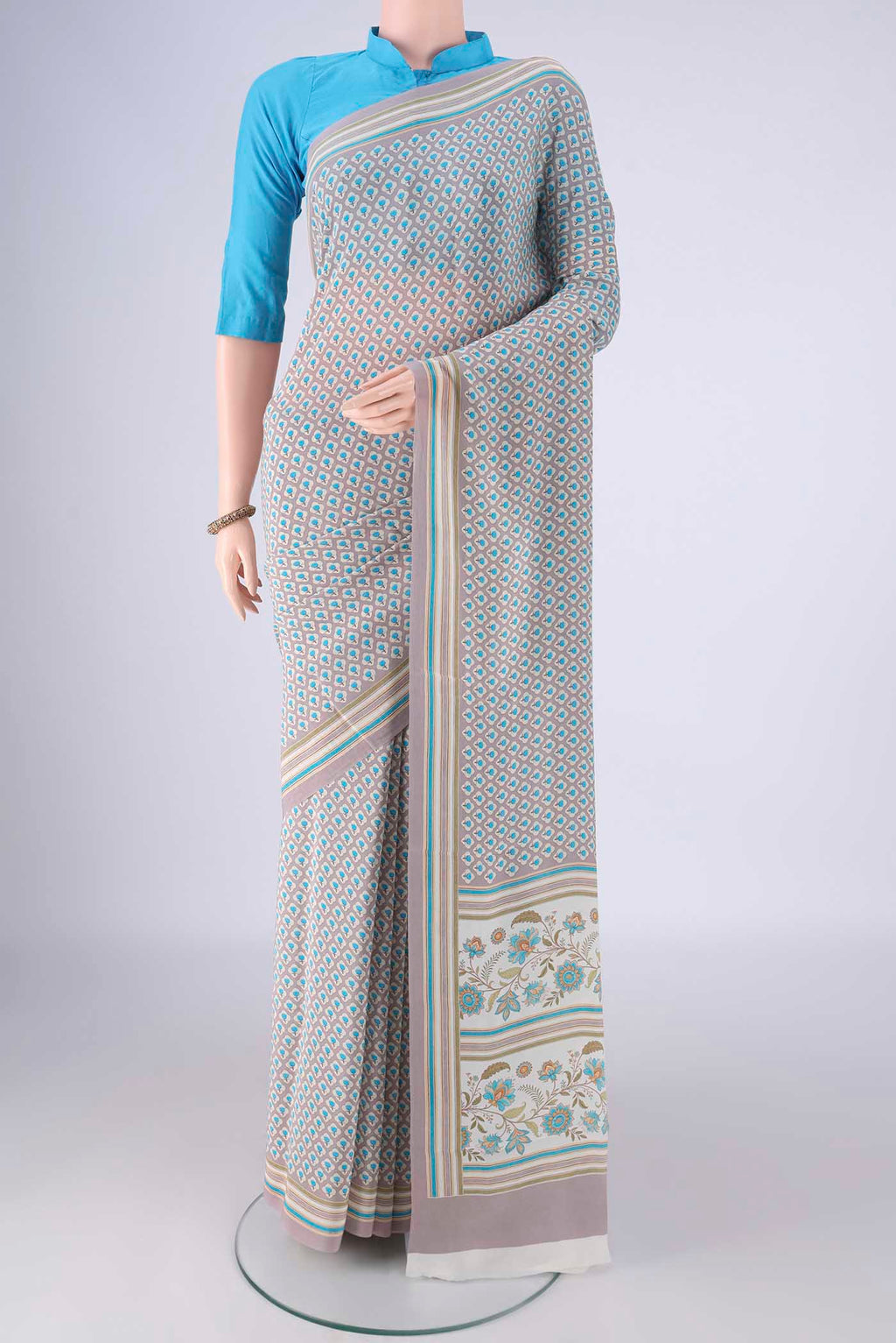 Grey Mysore Crepe Saree with Printed design on the body and Plain Border.  displayed on a mannequin