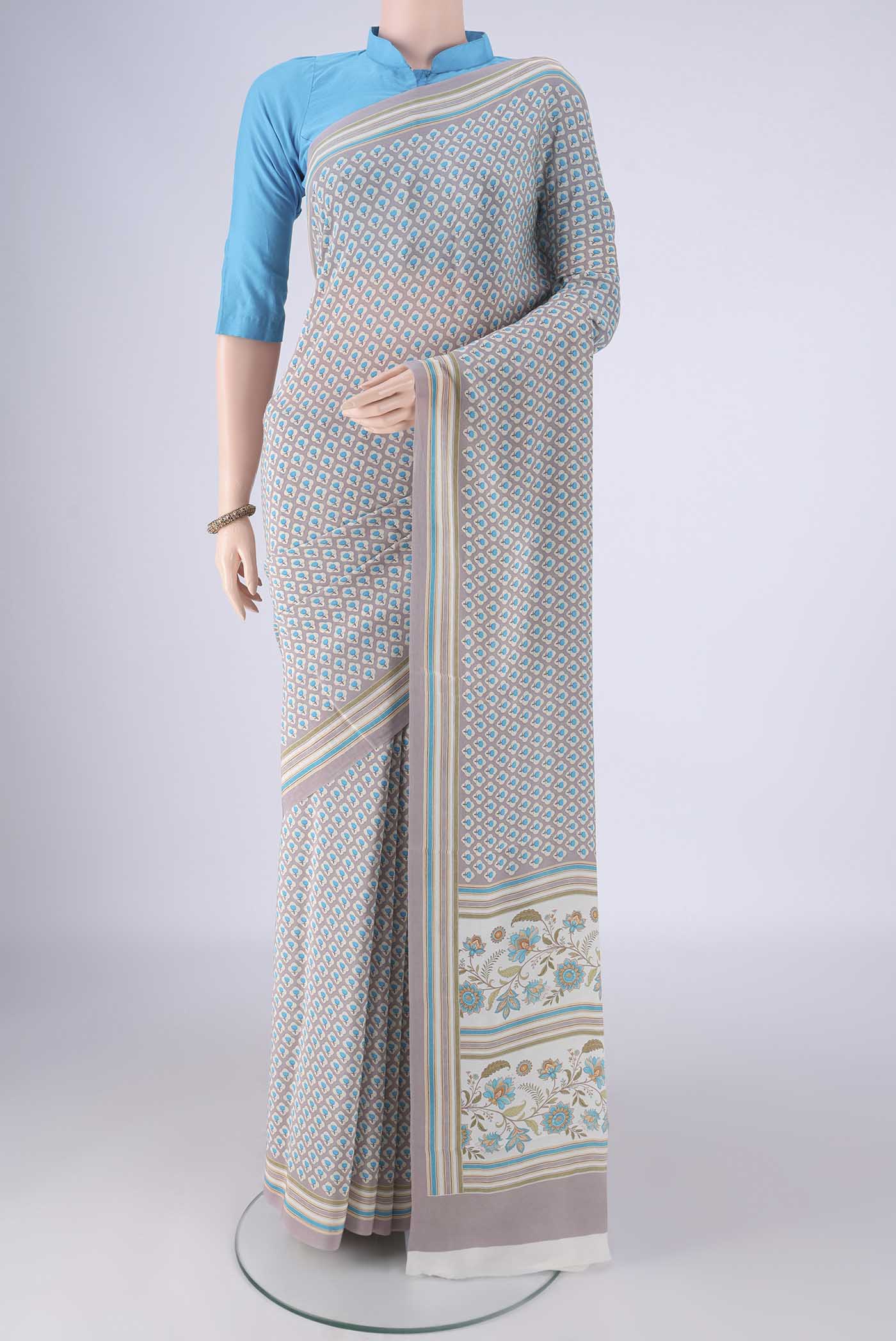 Grey Mysore Crepe Saree with Printed design on the body and Plain Border.  displayed on a mannequin