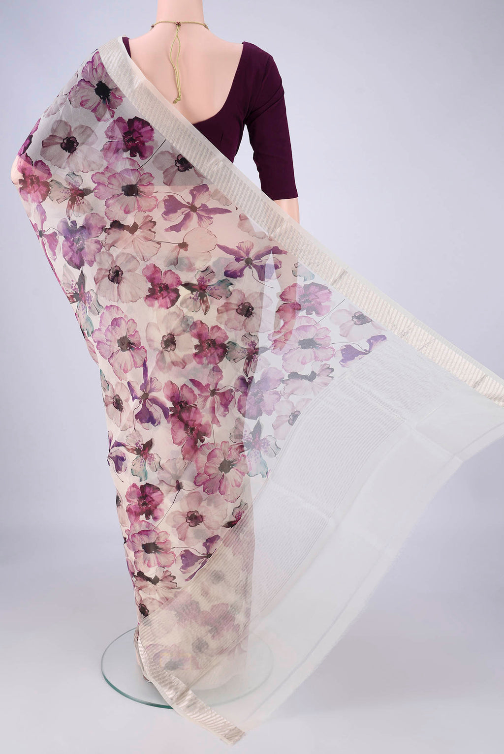 Flat view of Off White Organza Silk Saree with Printed design on the body and Zari Border. 