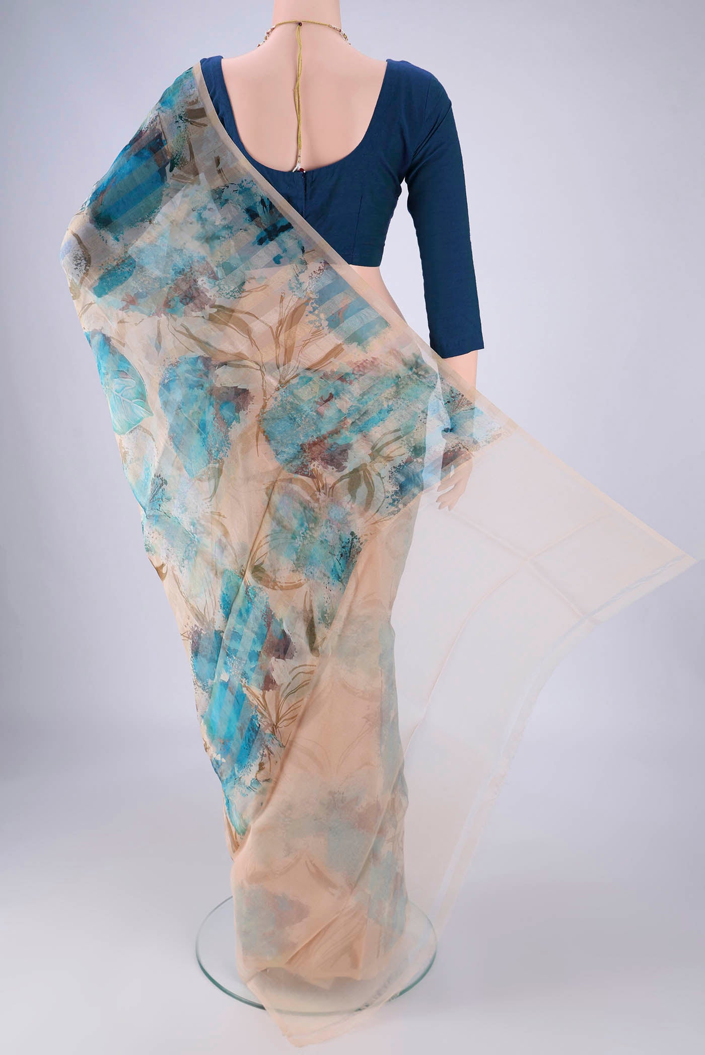 Flat view of Beige Organza Silk Saree with Printed design on the body and Without Border. 