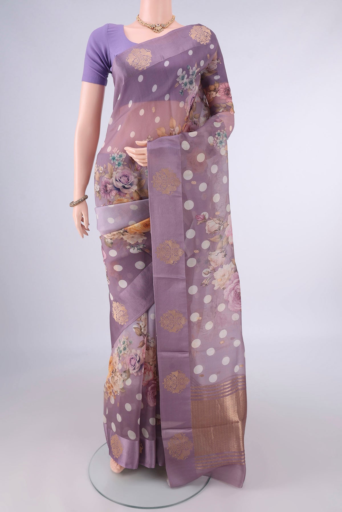 Lilac Organza Saree with Zari Butta on the body and Satin Border.  displayed on a mannequin