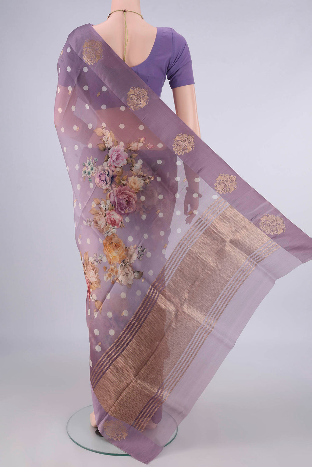 Flat view of Lilac Organza Saree with Zari Butta on the body and Satin Border. 